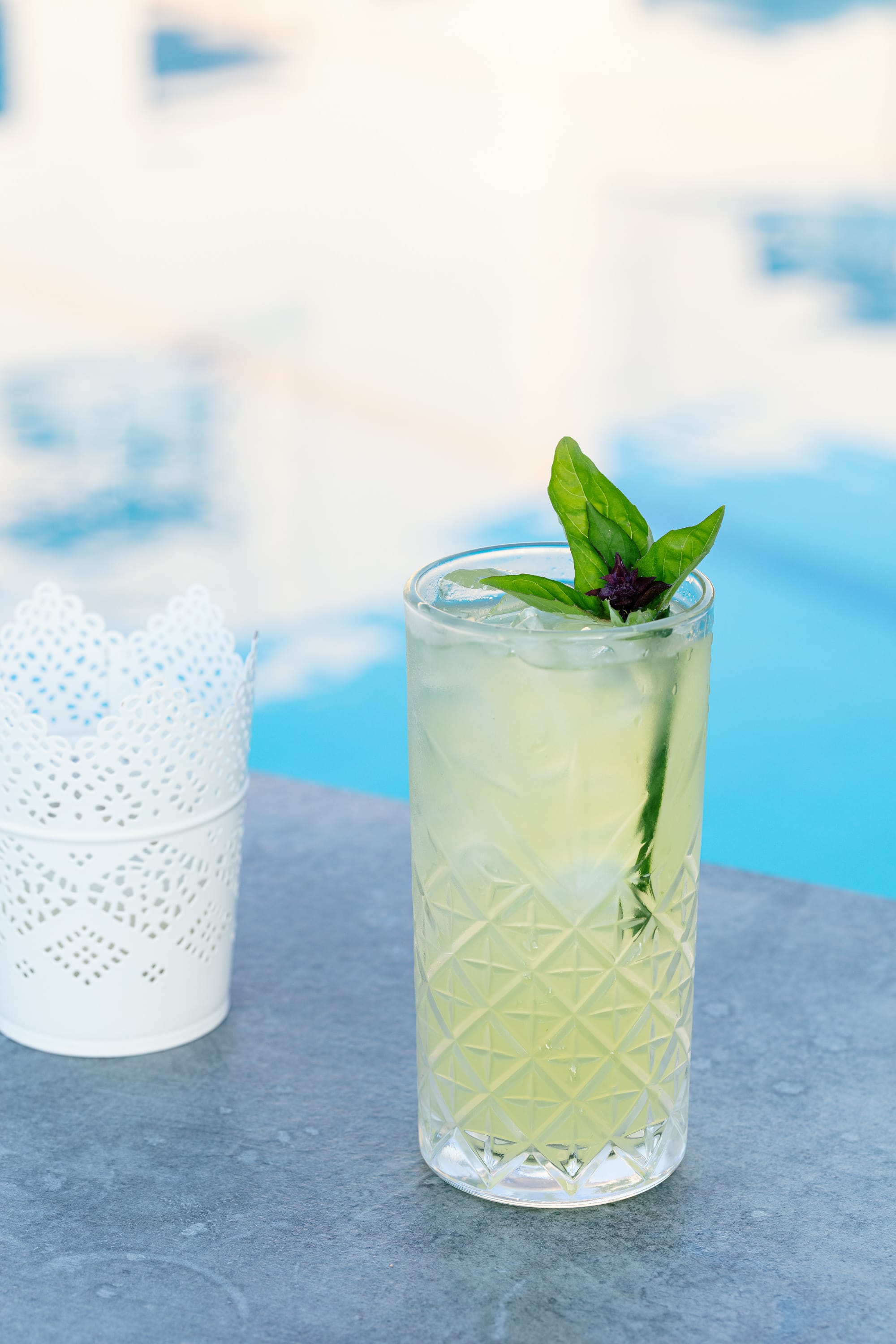 a glass of green liquid with a leaf on top