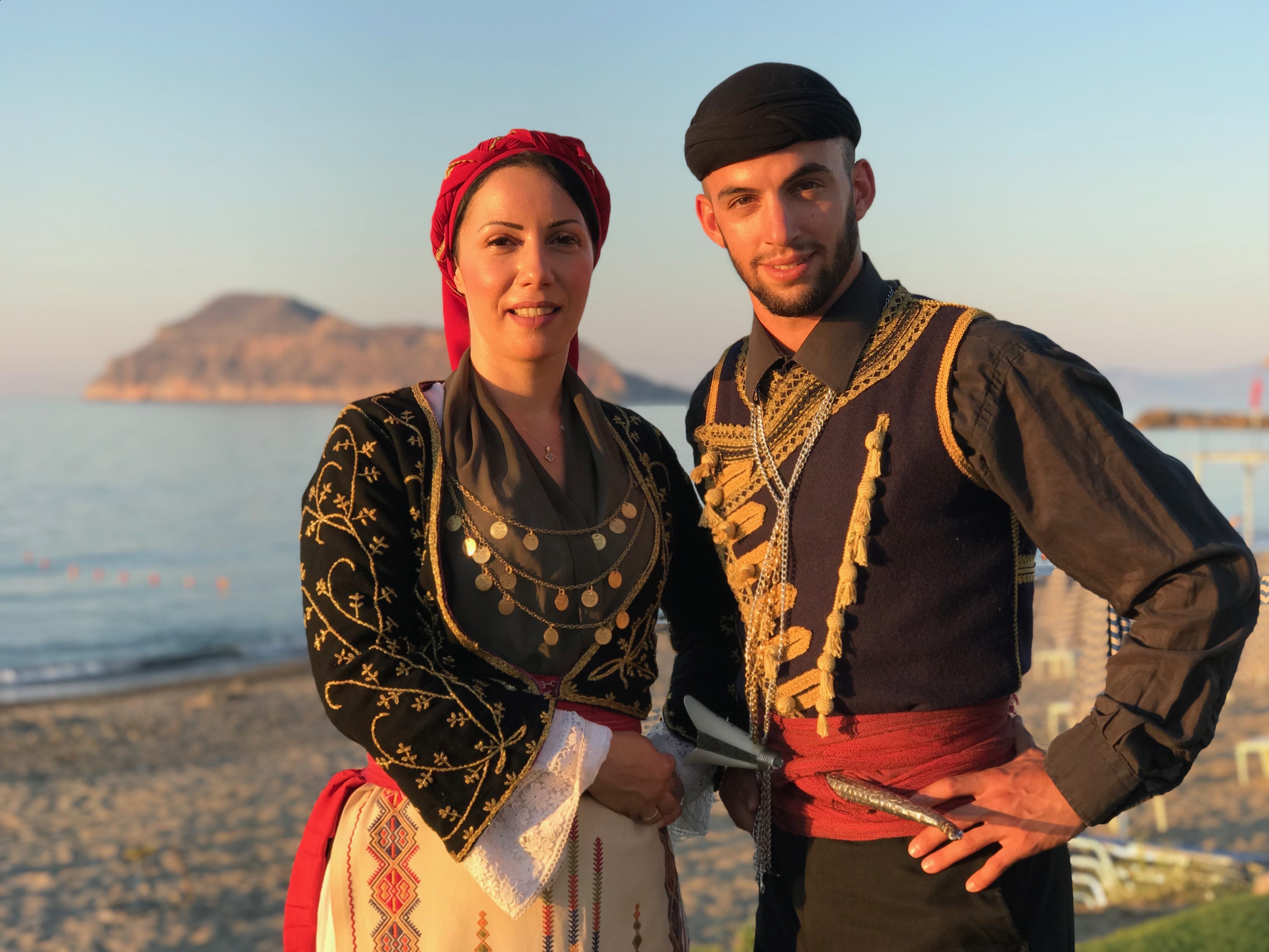 a man and woman posing for a picture on a beach