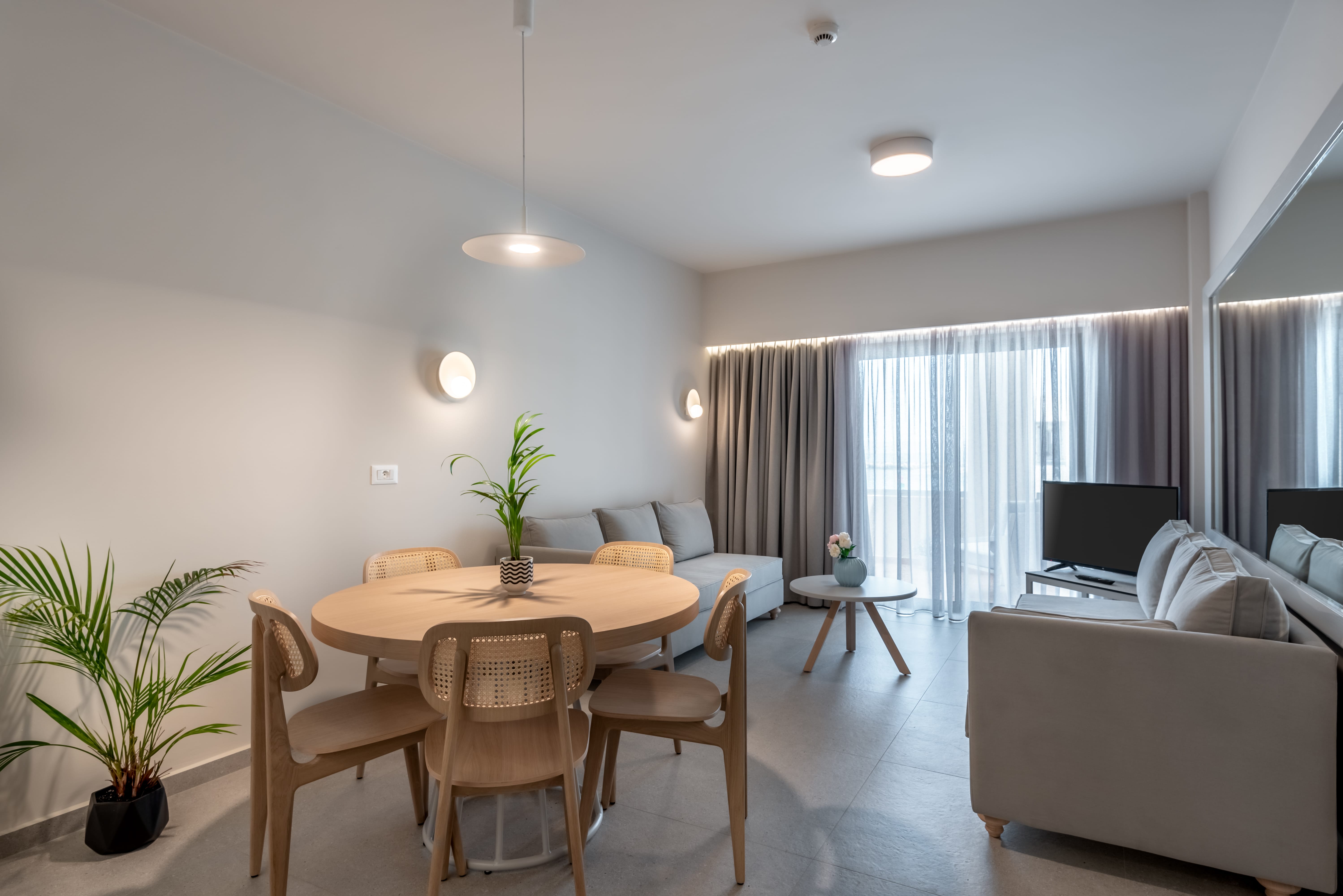 a living room with a table and chairs