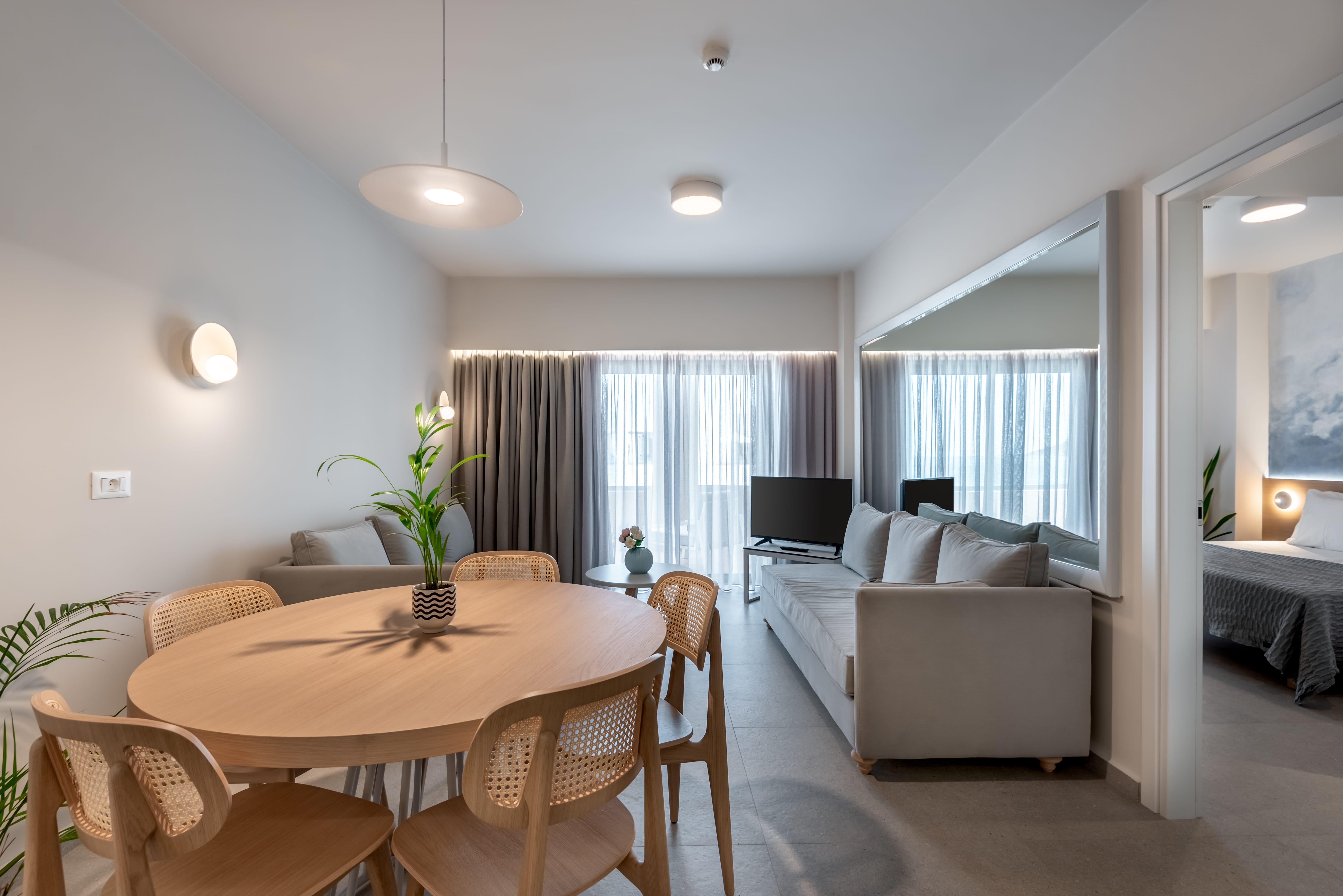 a living room with a large table and couches