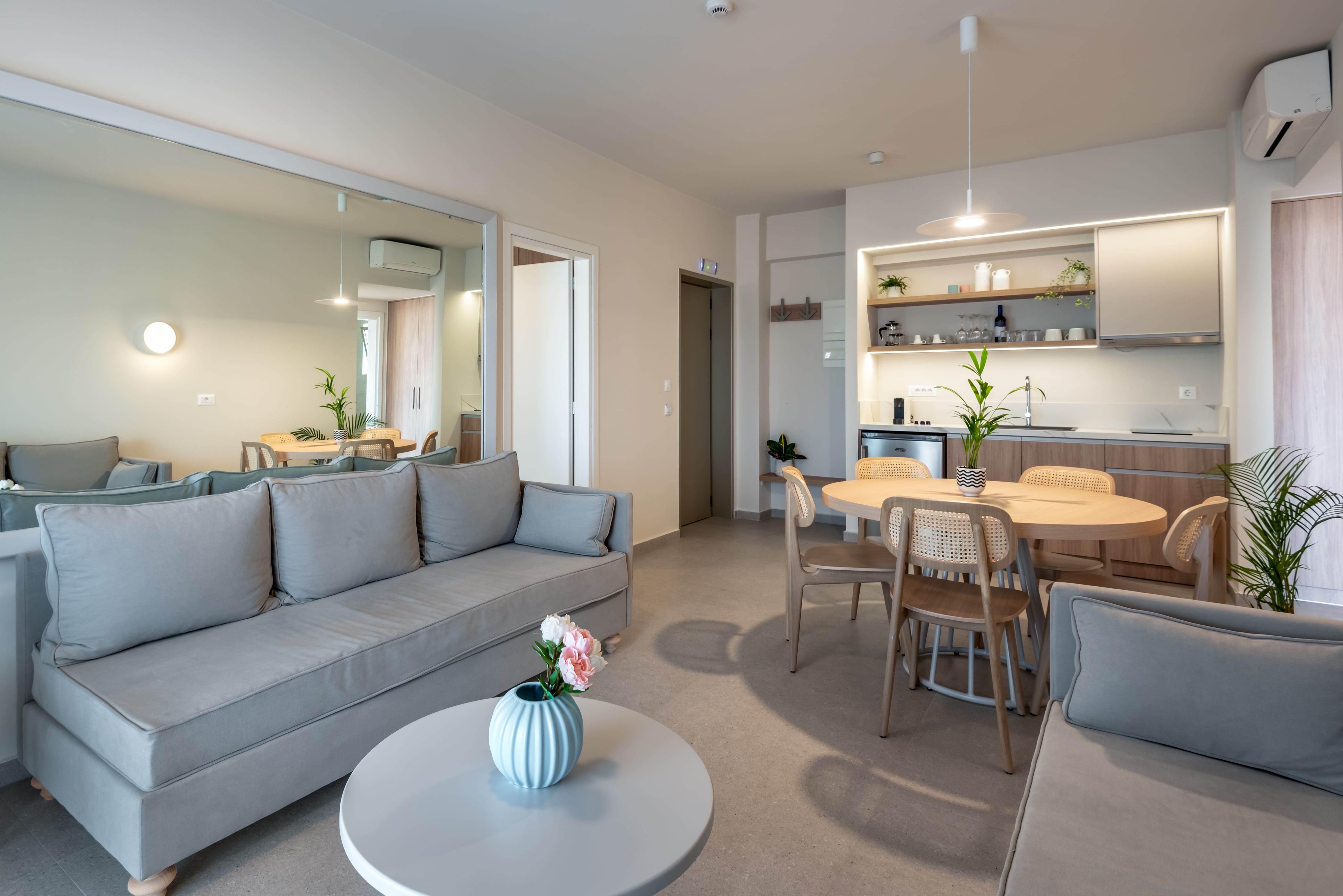 a living room with a couch and a dining table