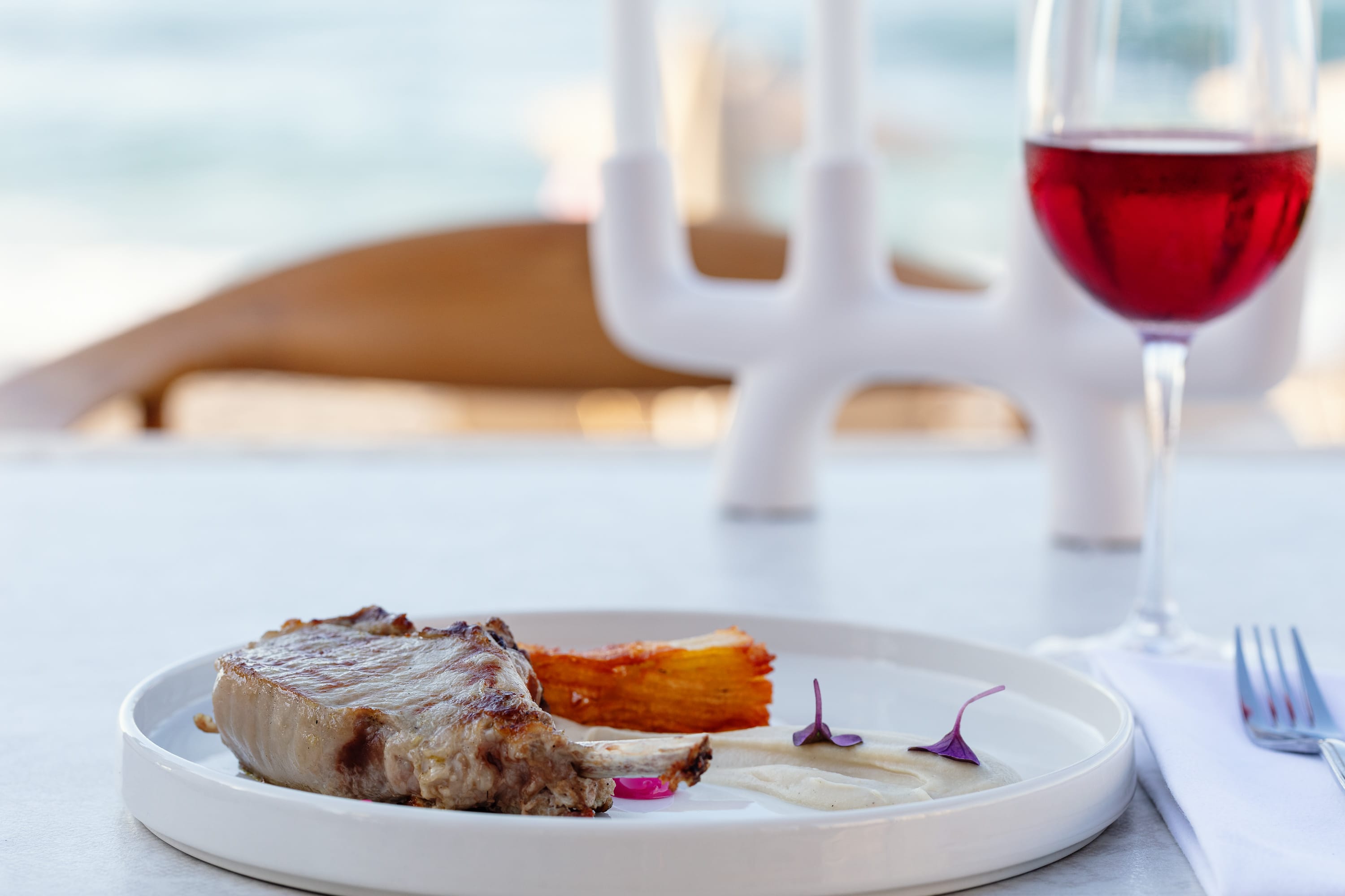 a plate of food and a glass of wine