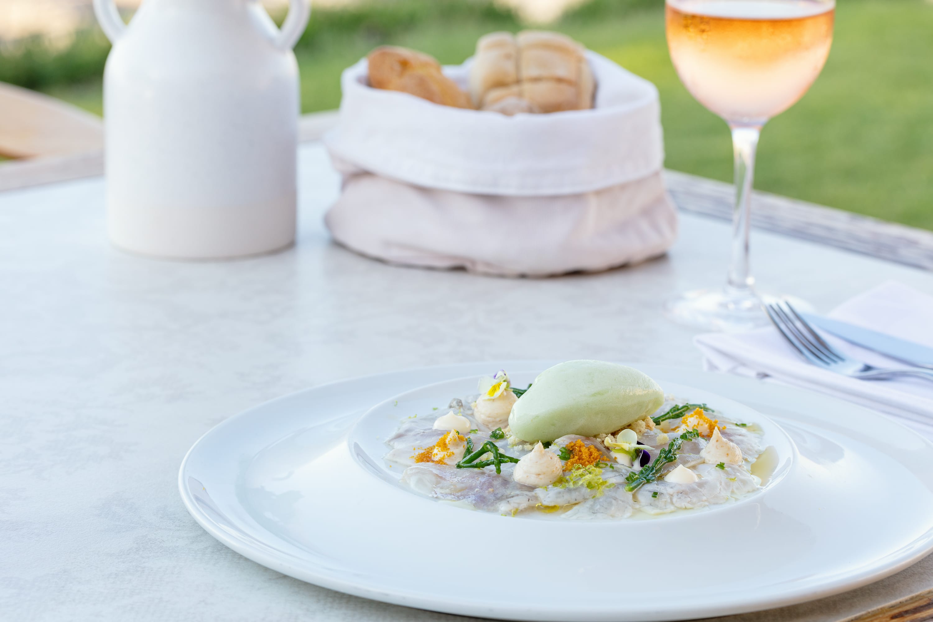 a plate of food and a glass of wine