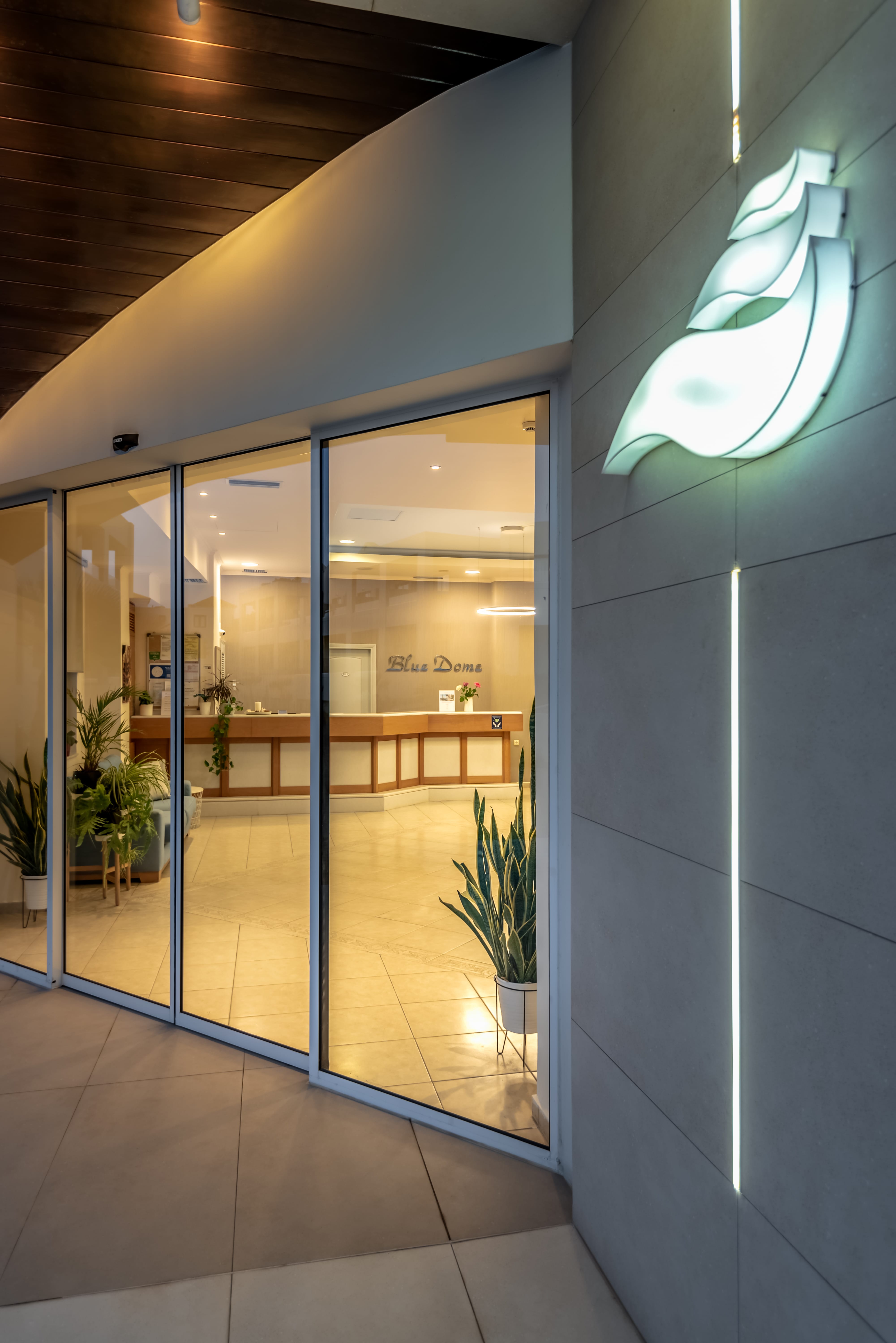 a glass walled building with a glass door and a glass wall