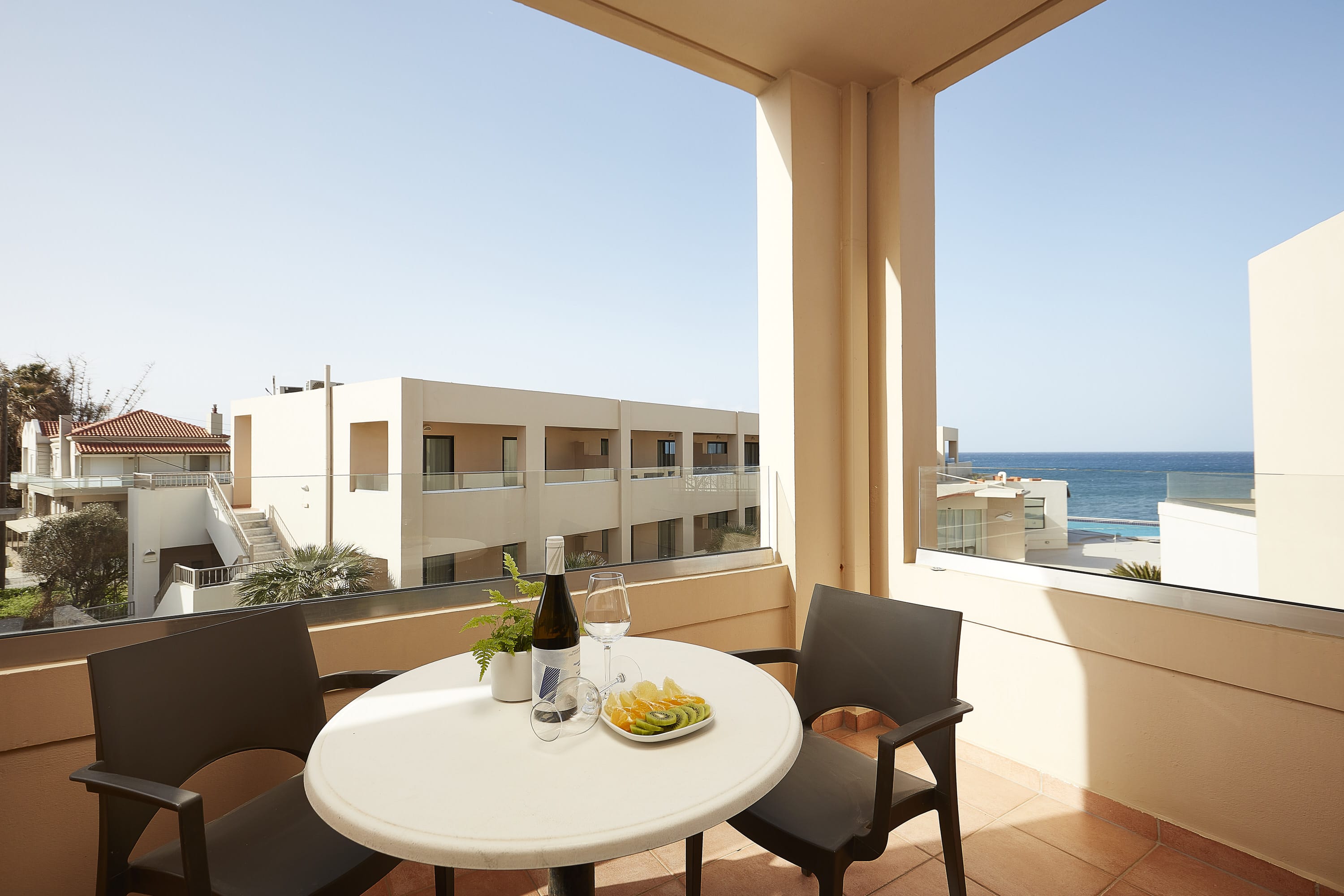 a table with wine bottles and glasses on it by a window