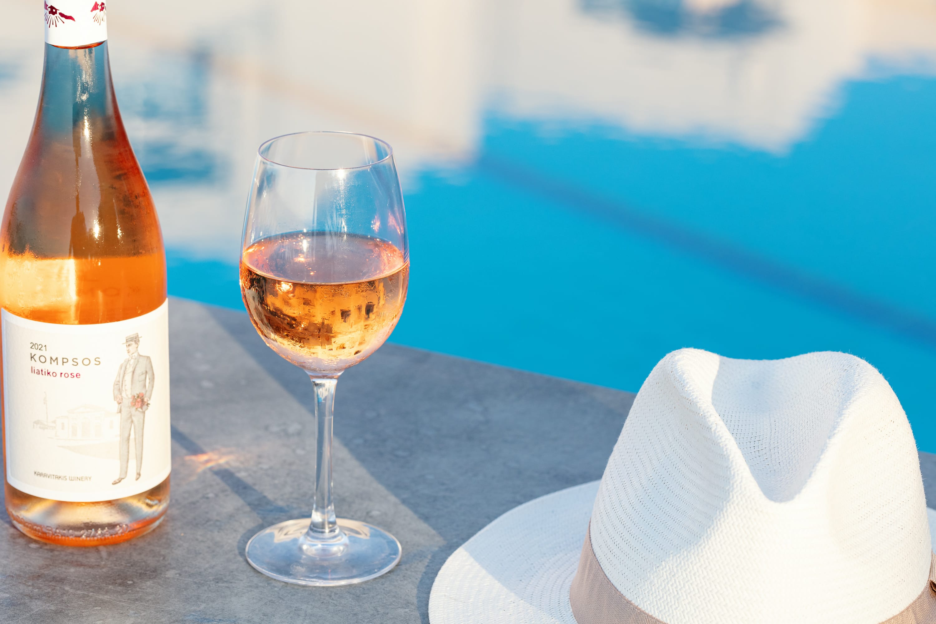 a bottle of alcohol next to a glass of beer