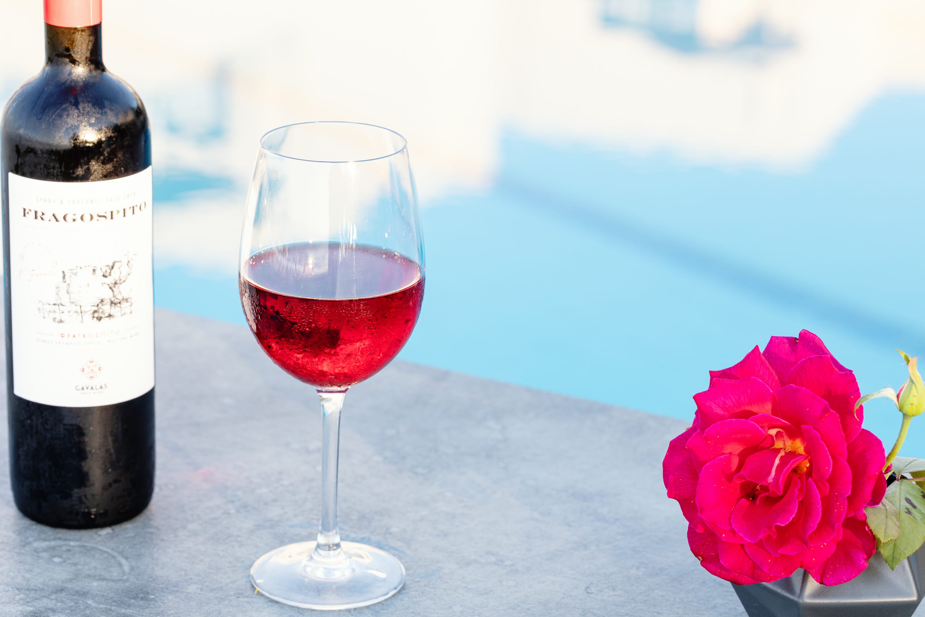 a bottle of wine next to a glass of wine