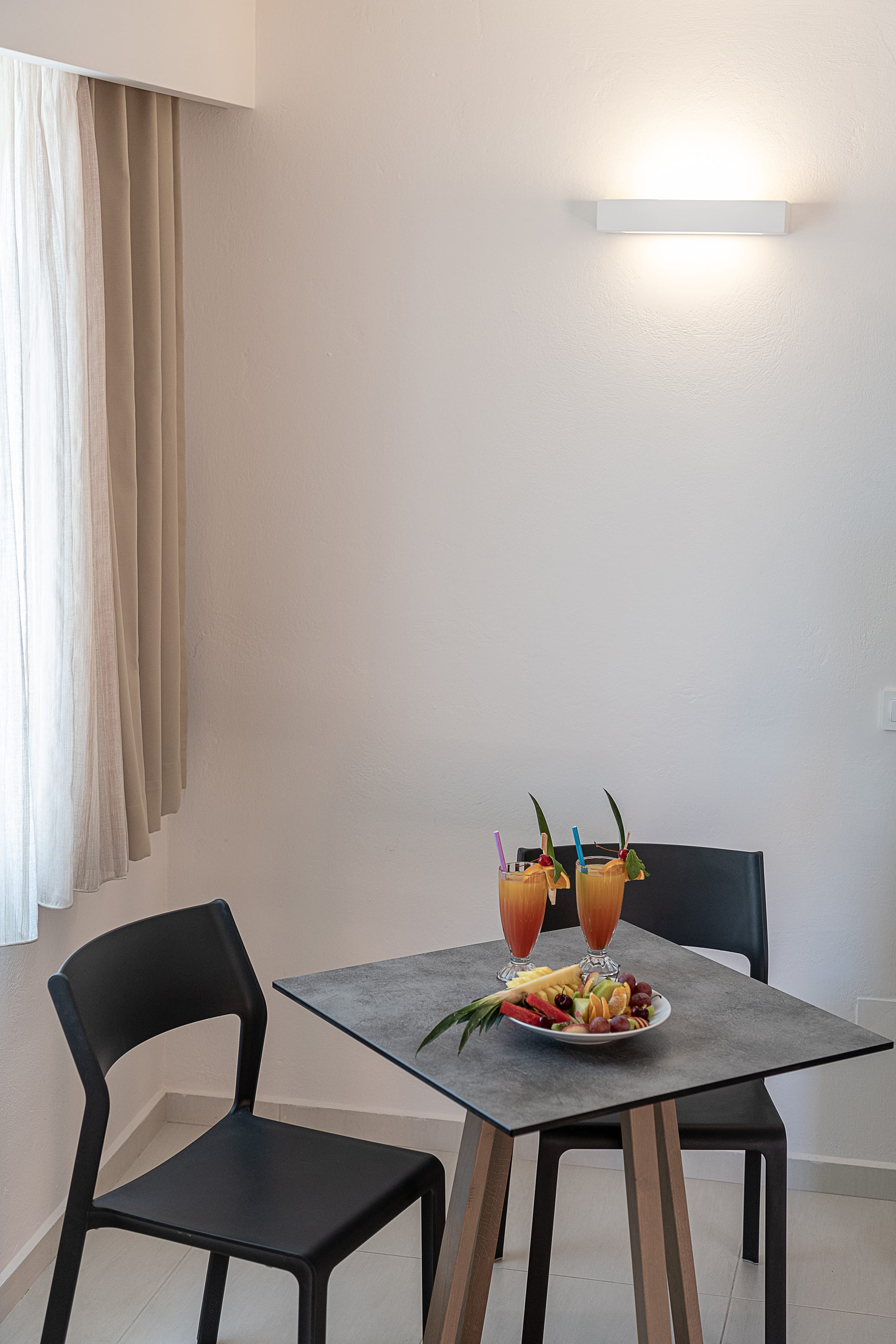 a table with chairs and a plate of food on it