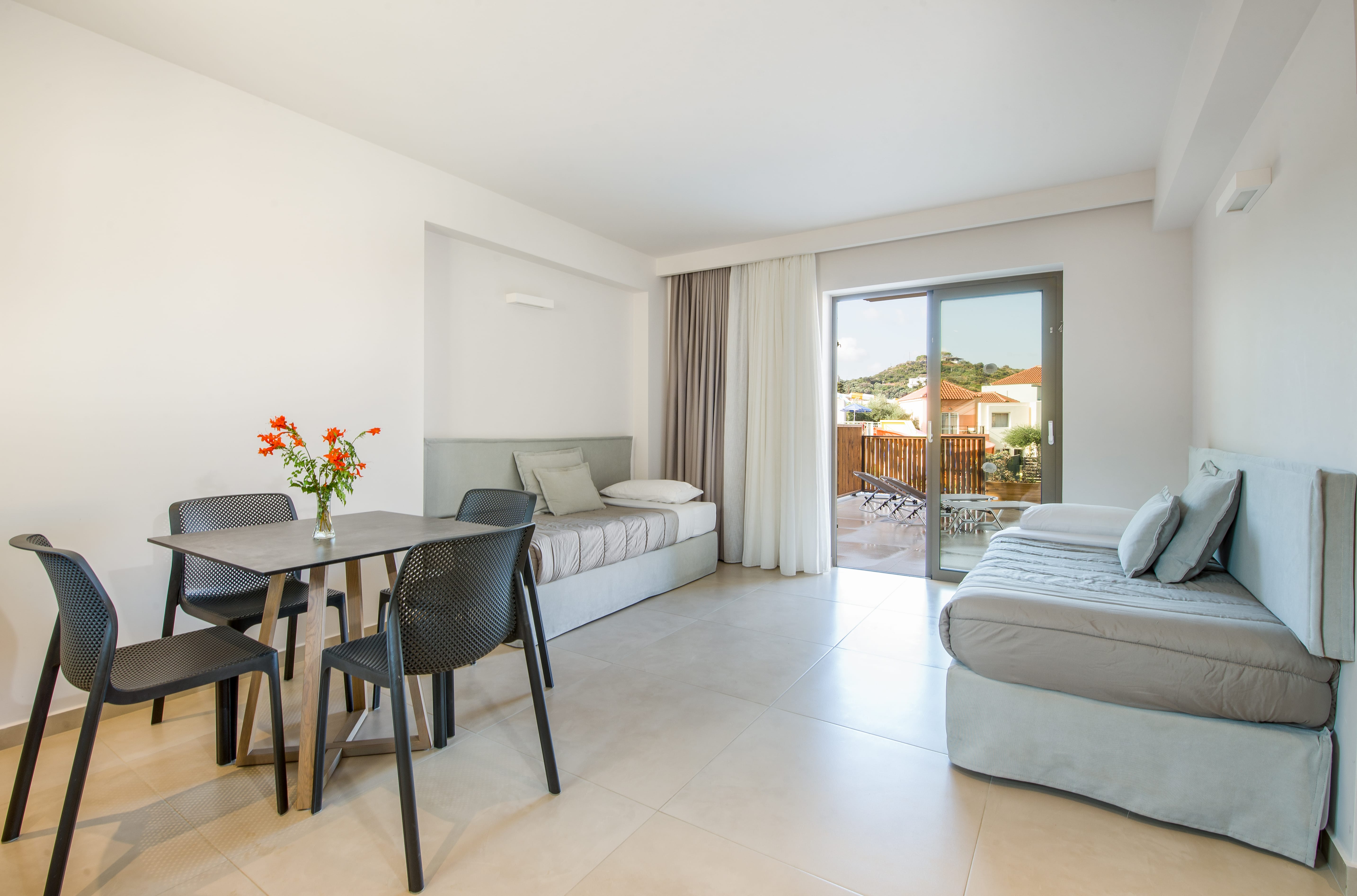 a living room with a table and chairs