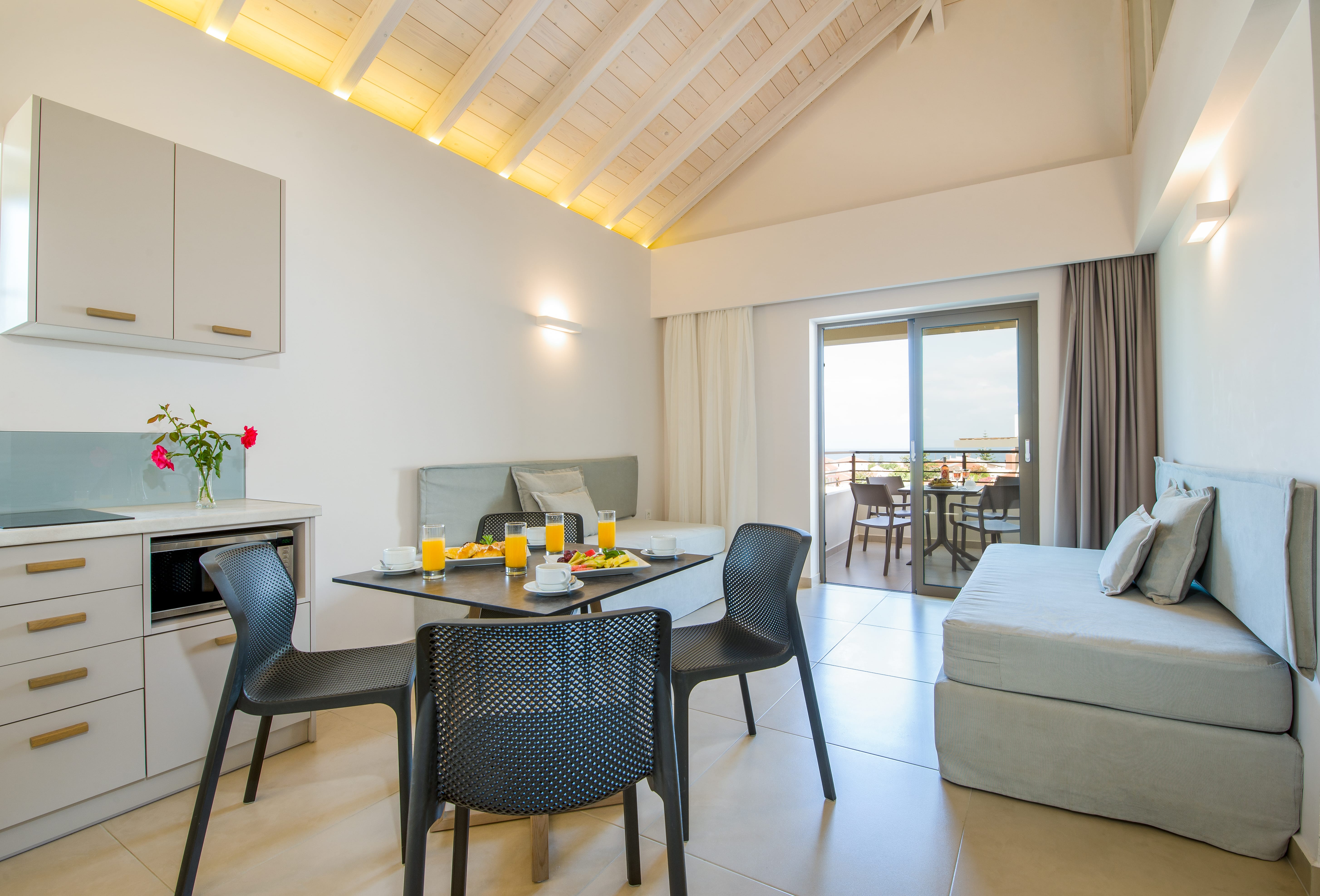 a living room with a table and chairs