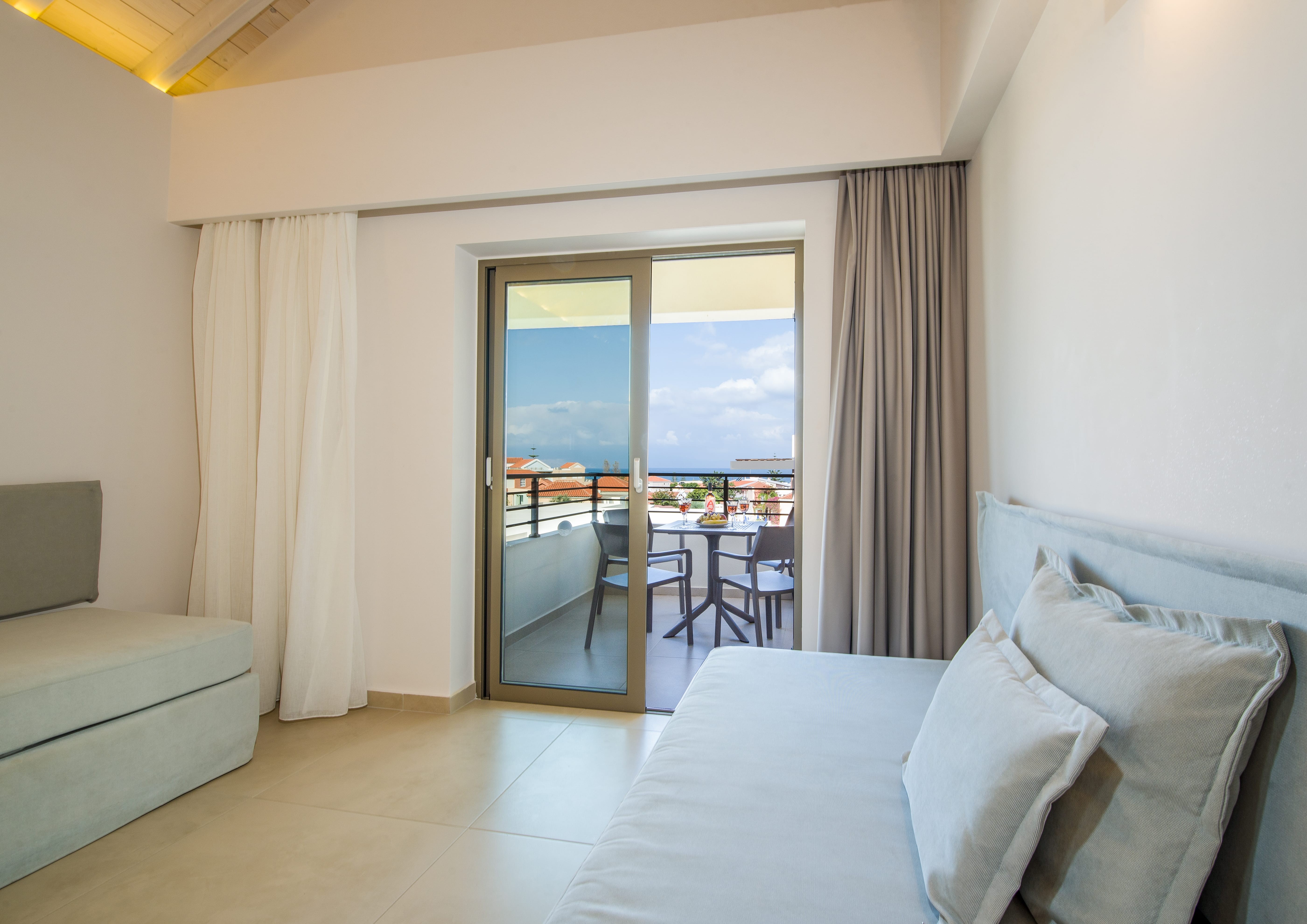 a room with a view of the ocean and a patio