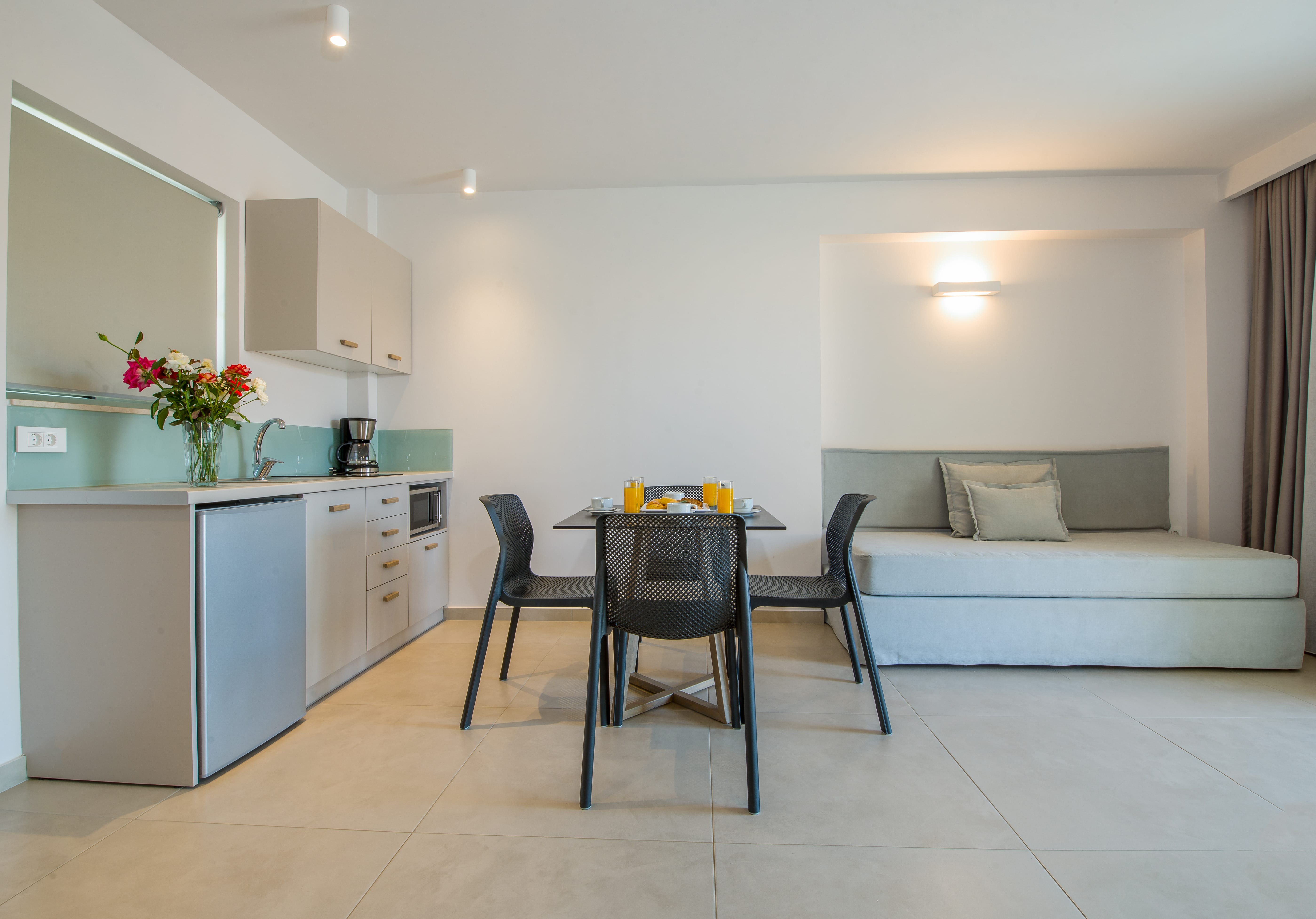 a room with a couch and chairs