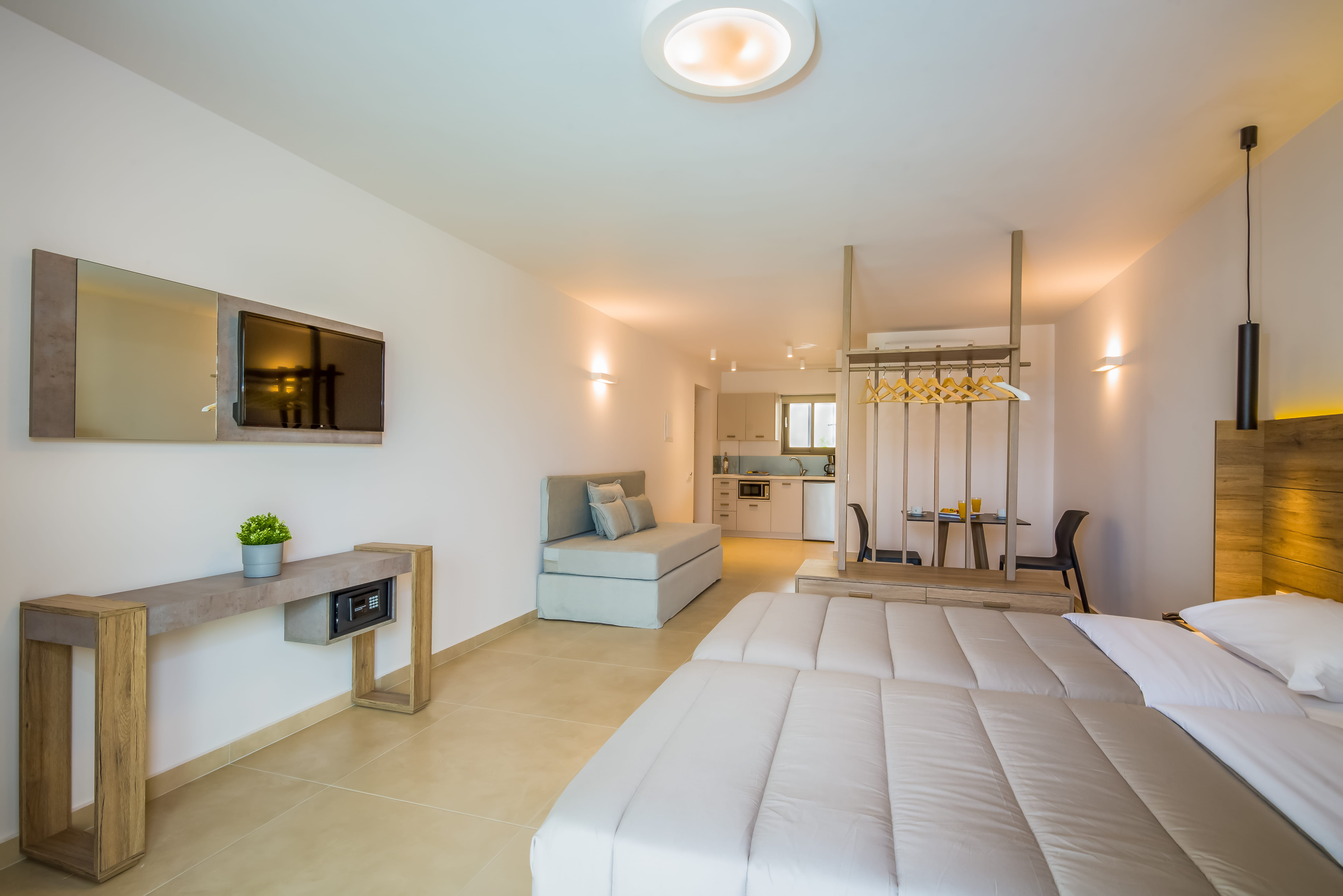 a large hotel room with a bed and a desk