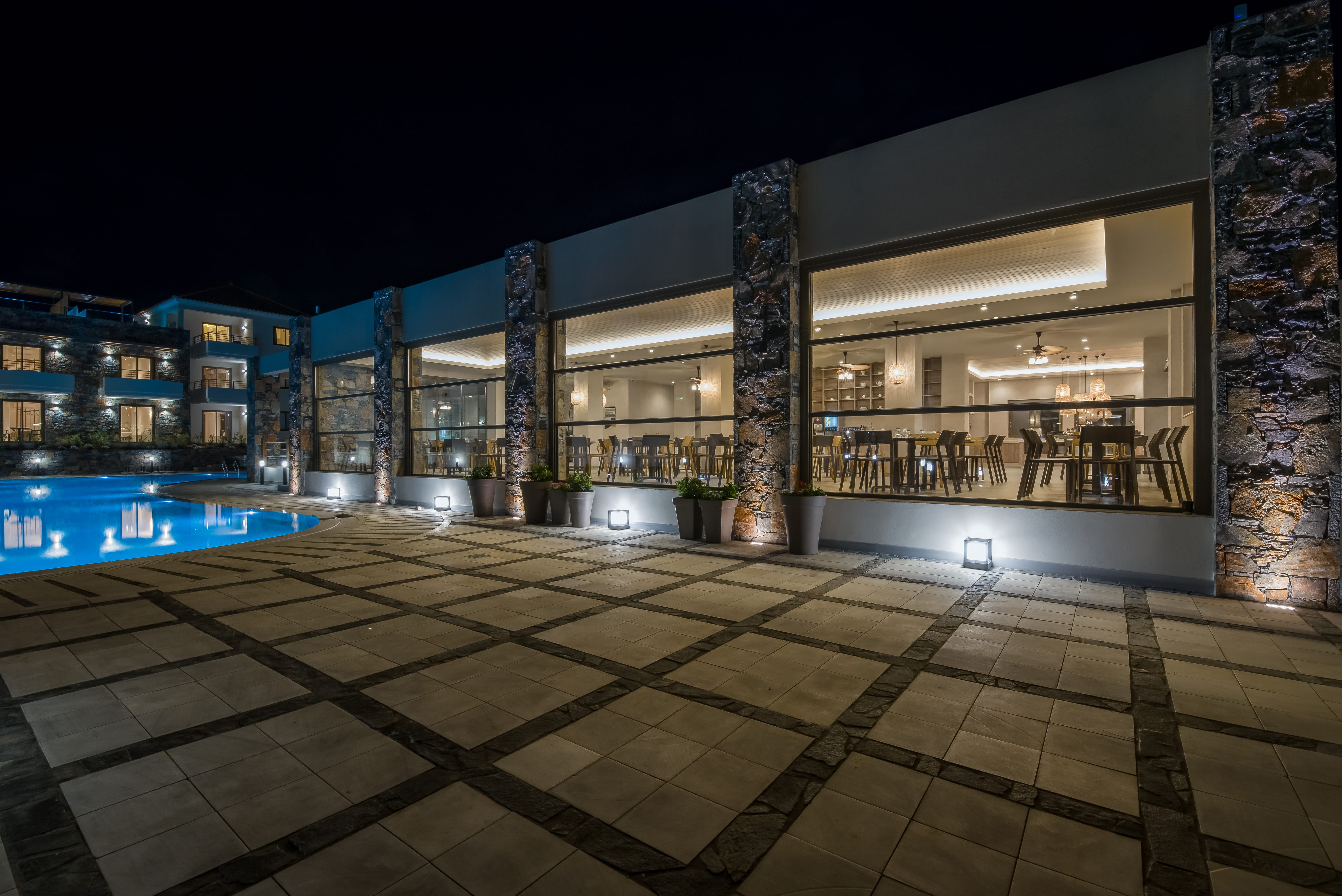 a building with a pool and a large glass wall