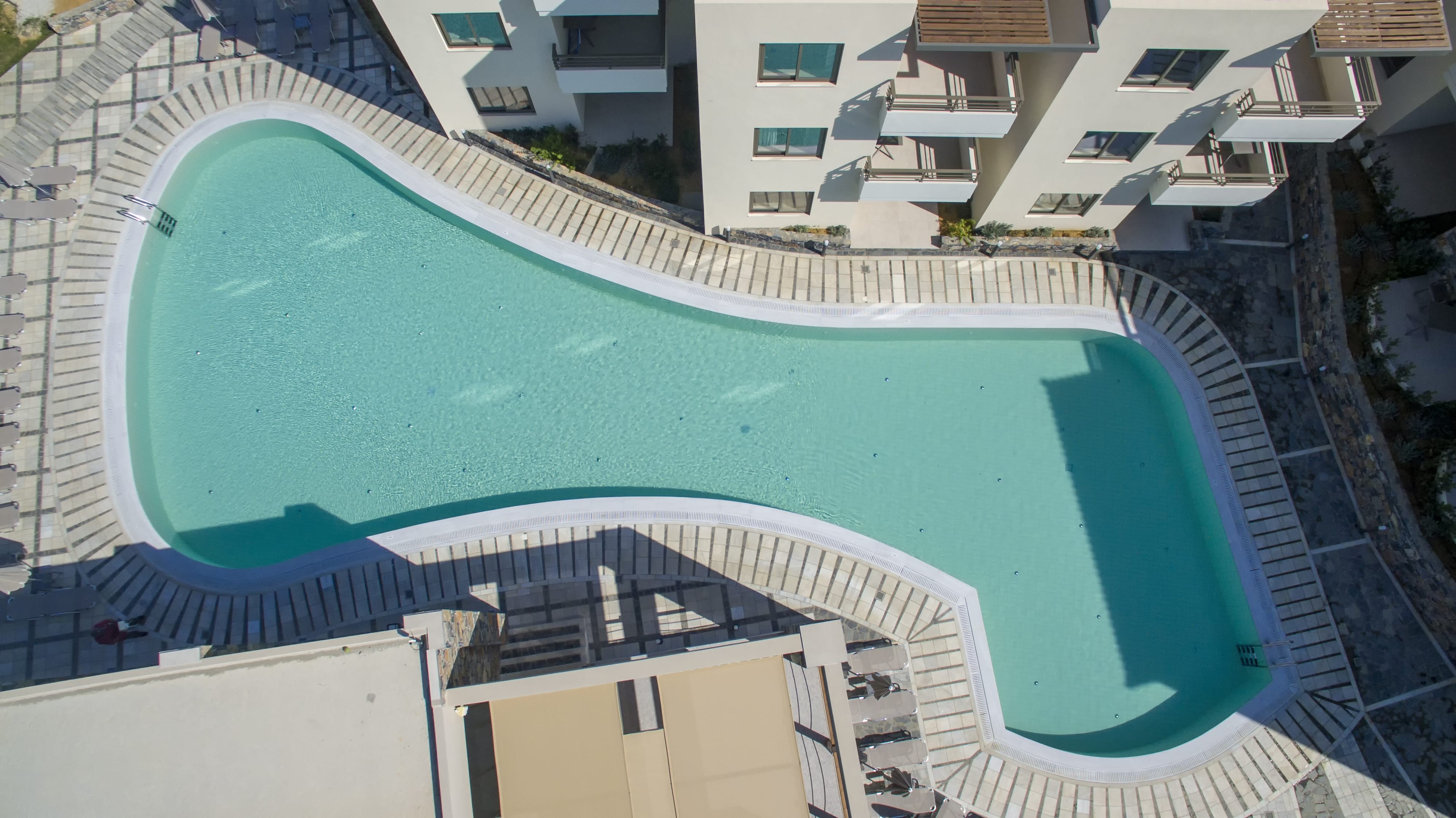 a swimming pool with a building in the background