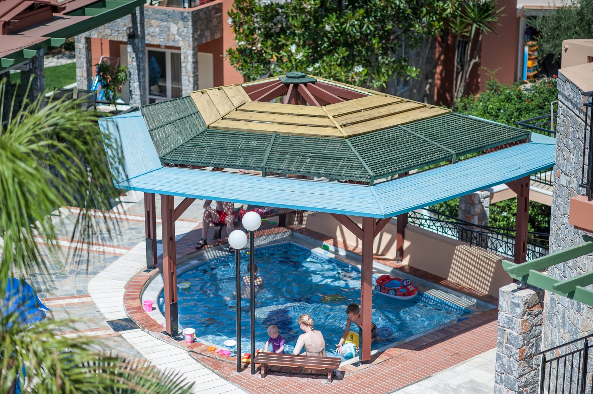 a pool with a slide and people in it