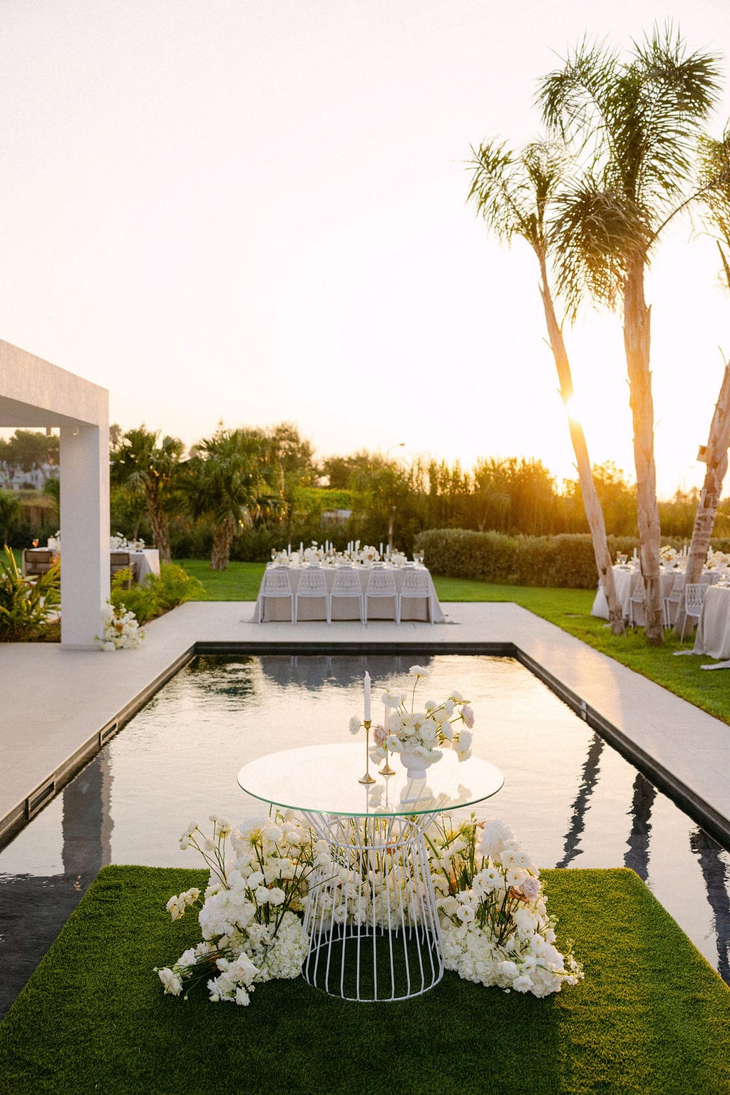 Wedding ceremony arch at sunset by the pool, TAF Beach Villas
