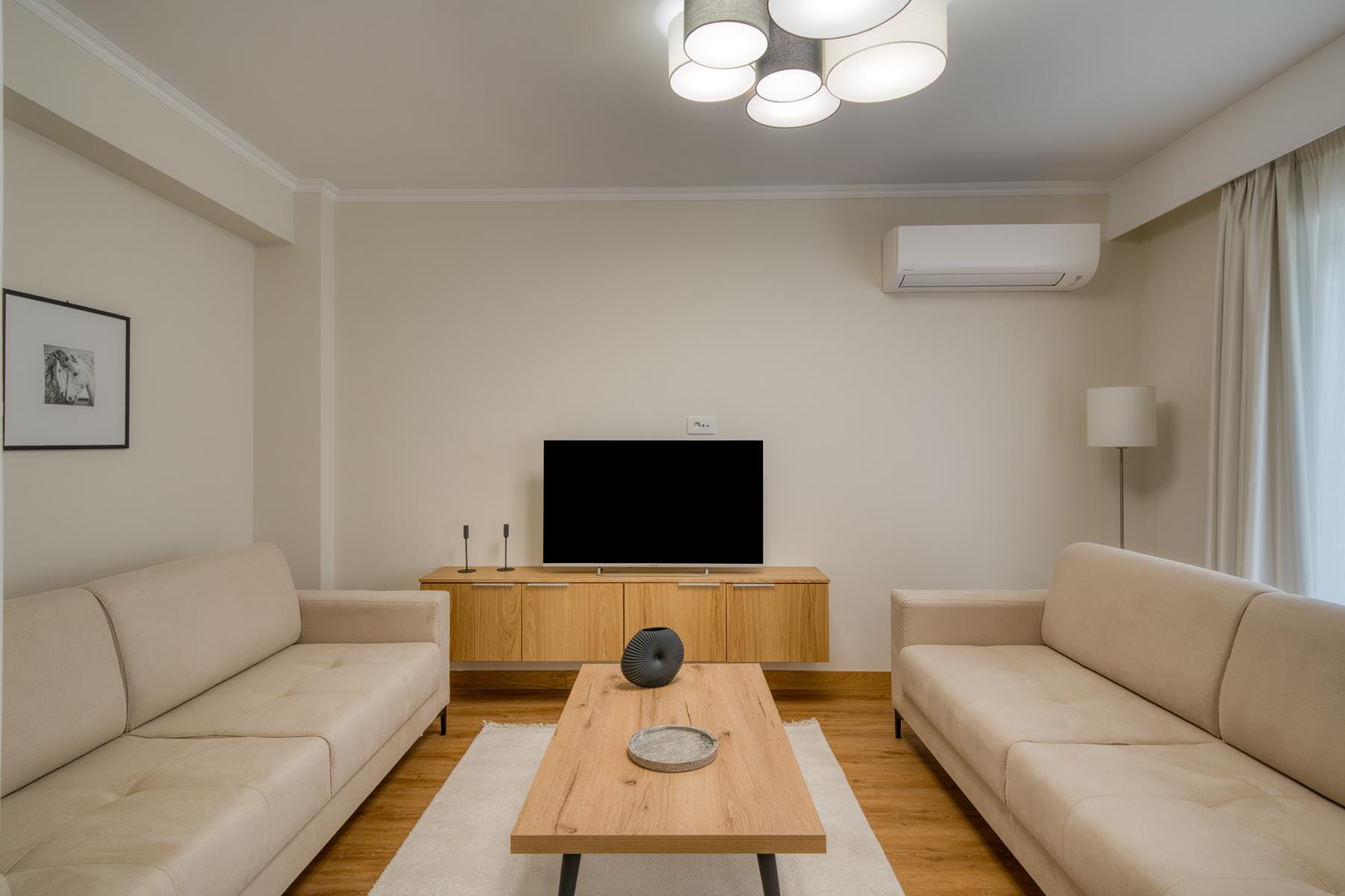 a living room with a tv and couches