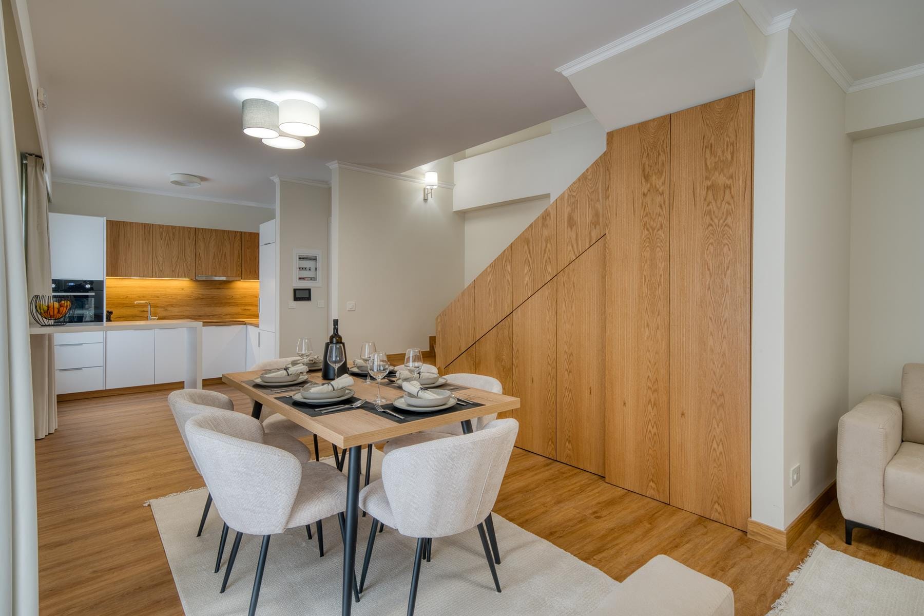 a dining room with a wood paneled wall
