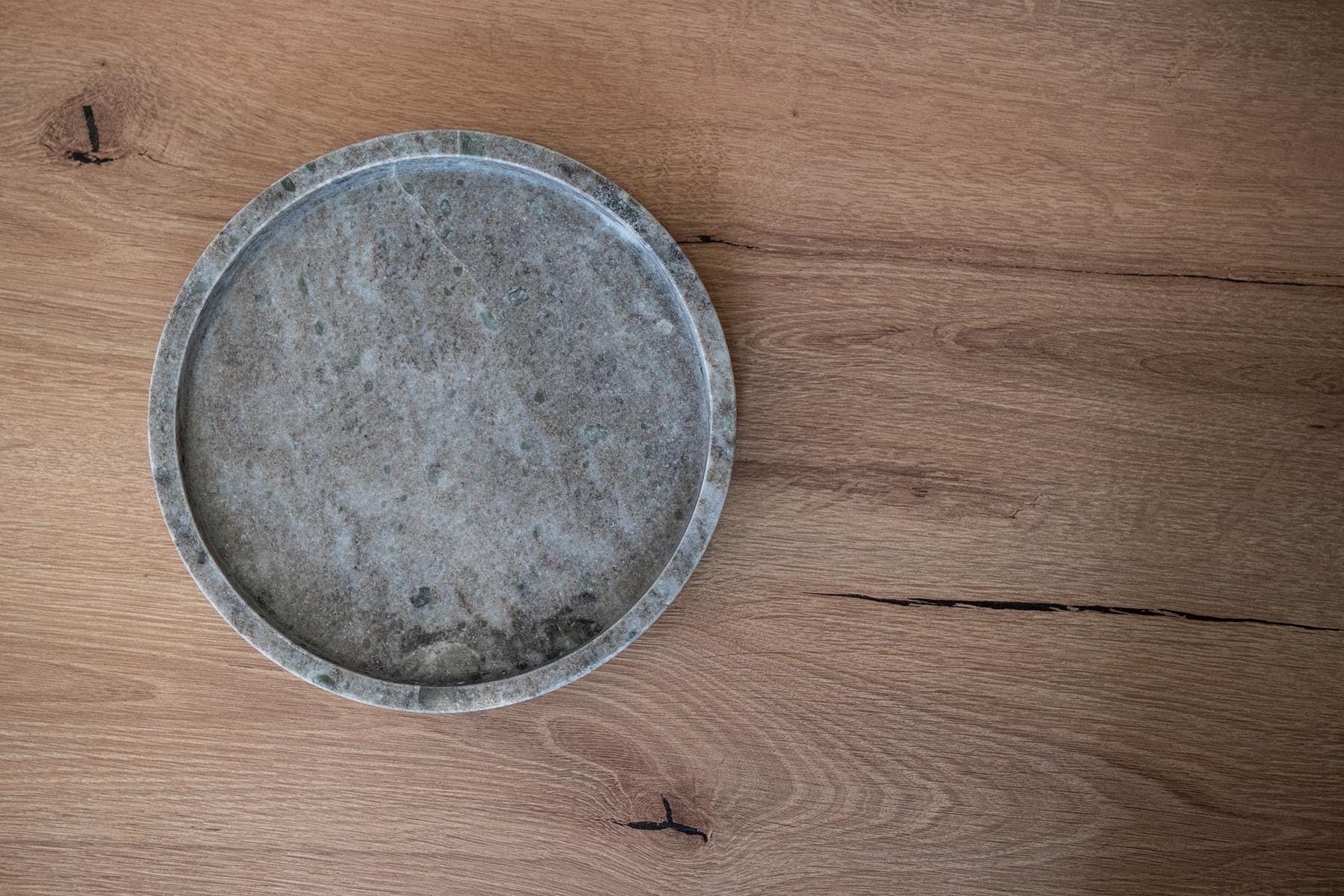 a round metal object on a wooden surface