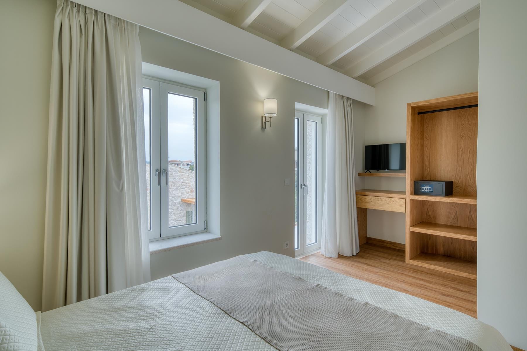 a bedroom with a bed and a television