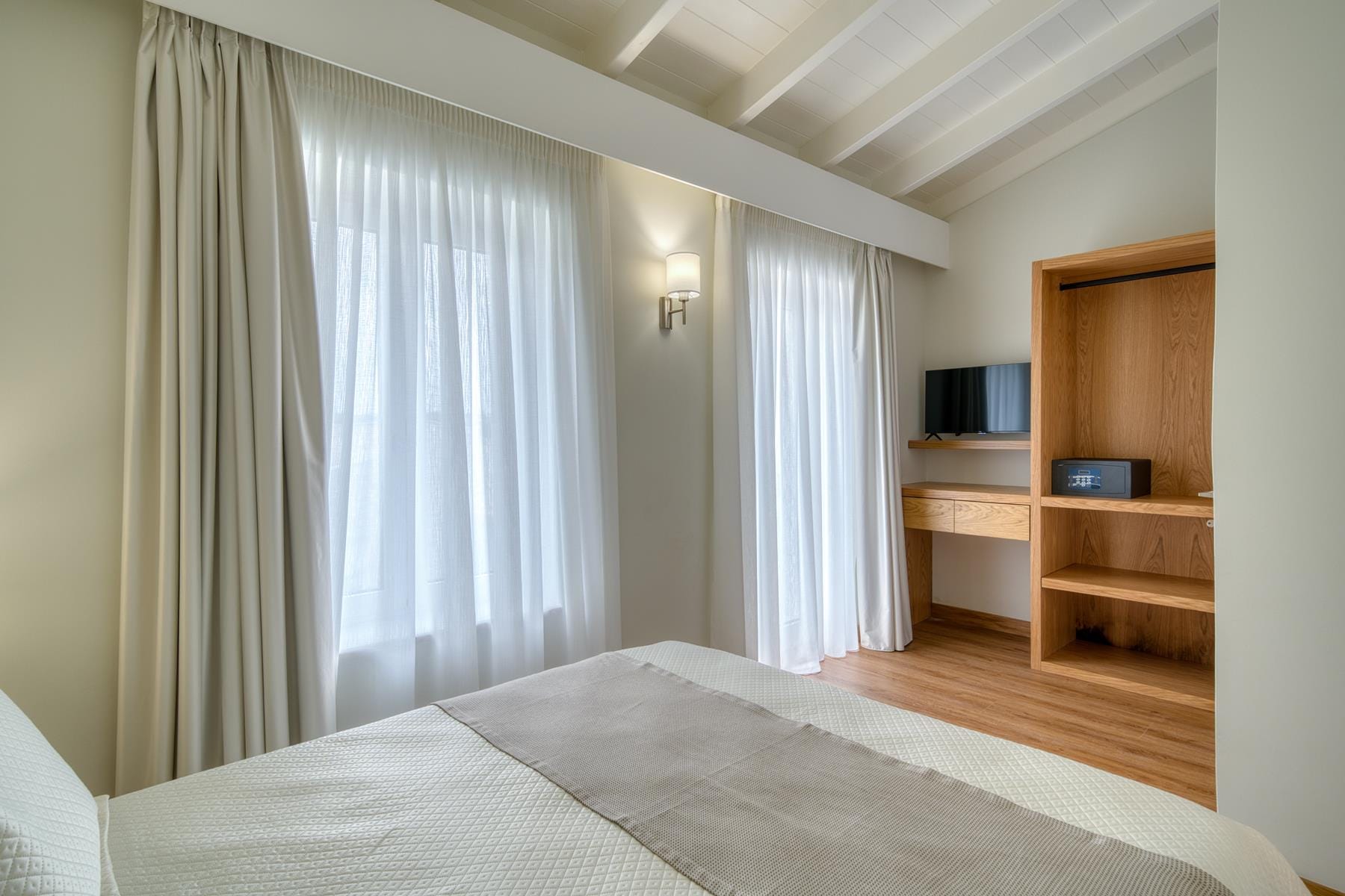 a room with a bed and a window