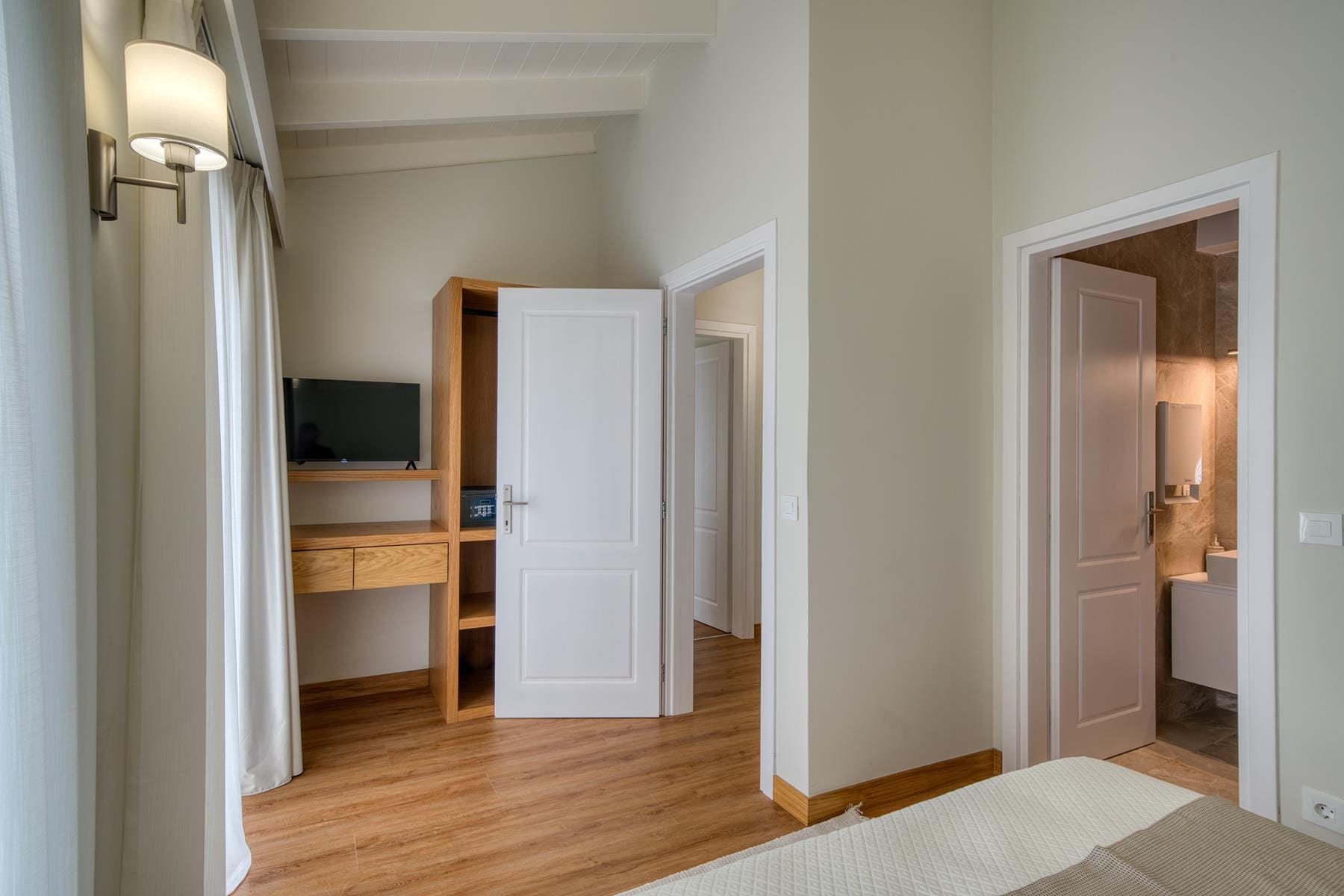 a room with a wood floor and white walls