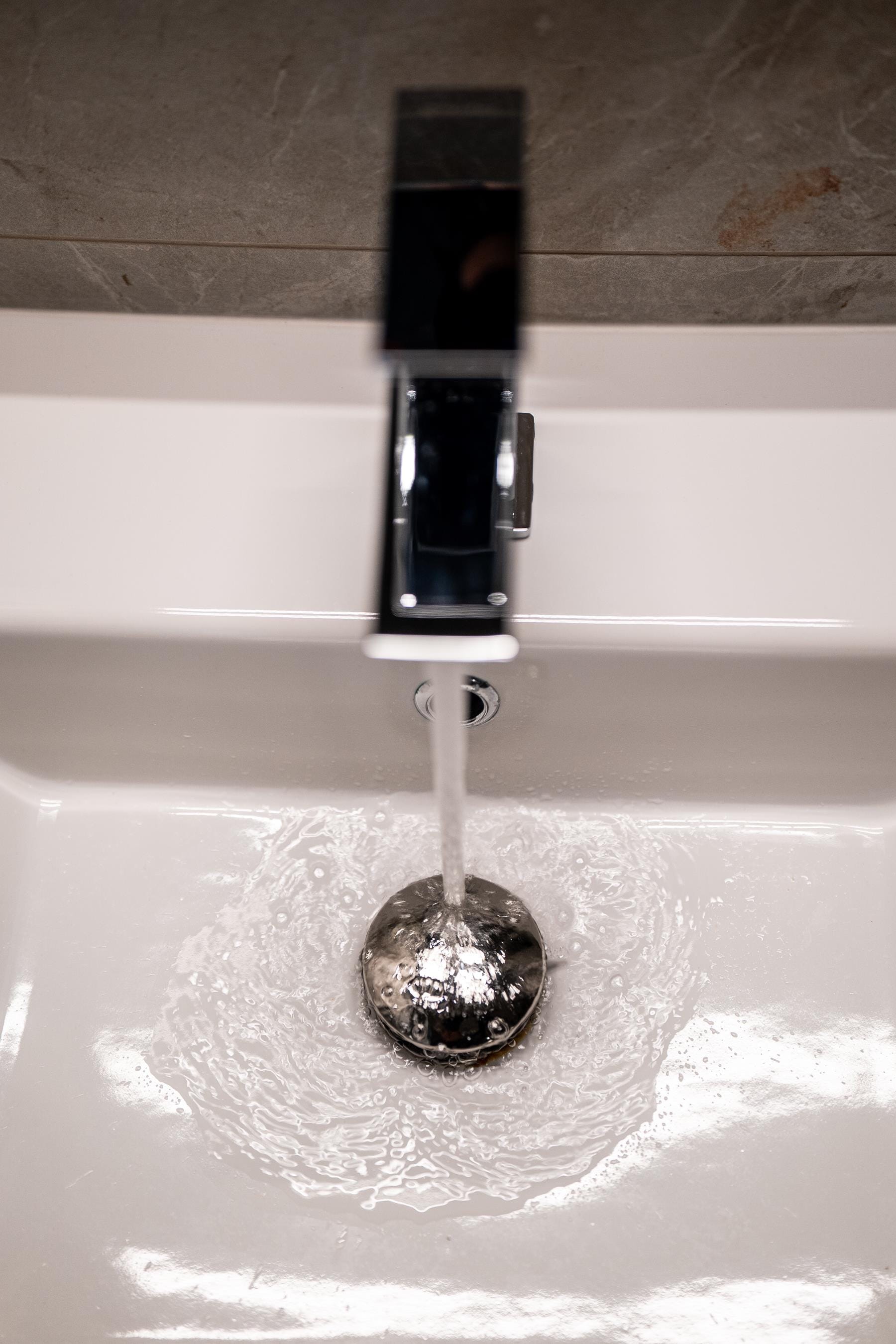 a water faucet with a black plug