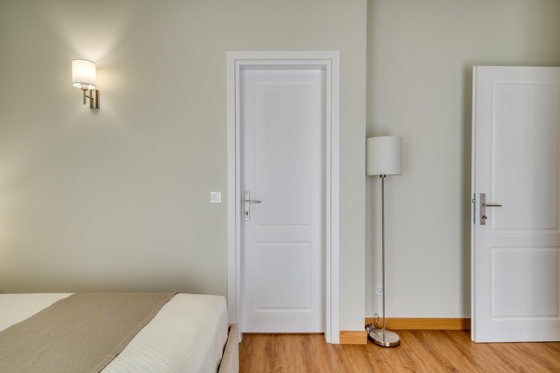 a room with a bed and a lamp