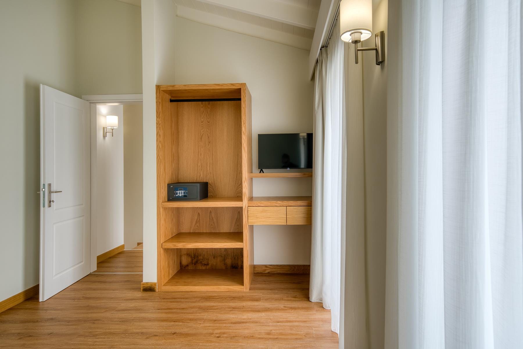 a room with a tv and a shelf