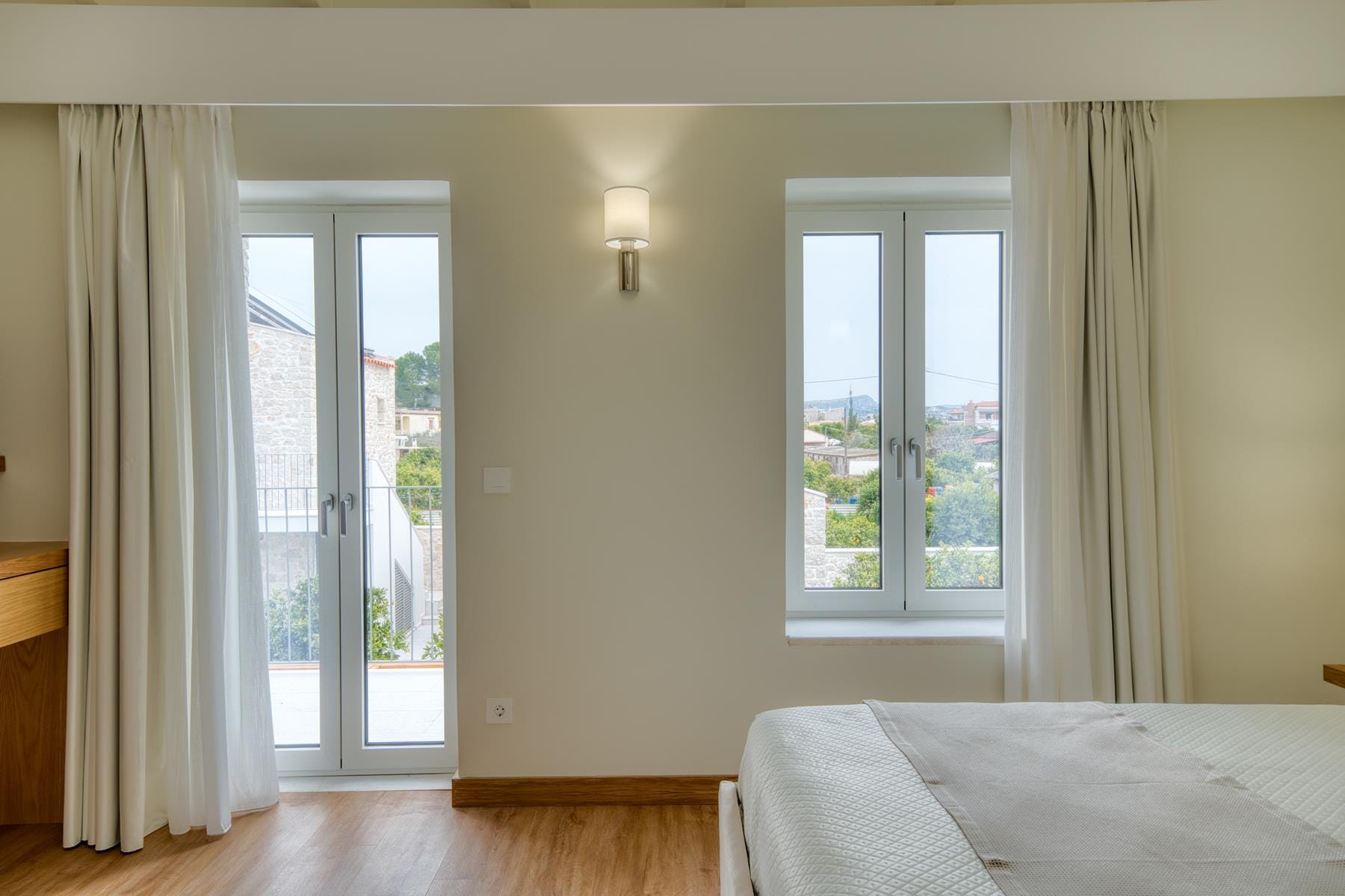 a room with a bed and a window with curtains