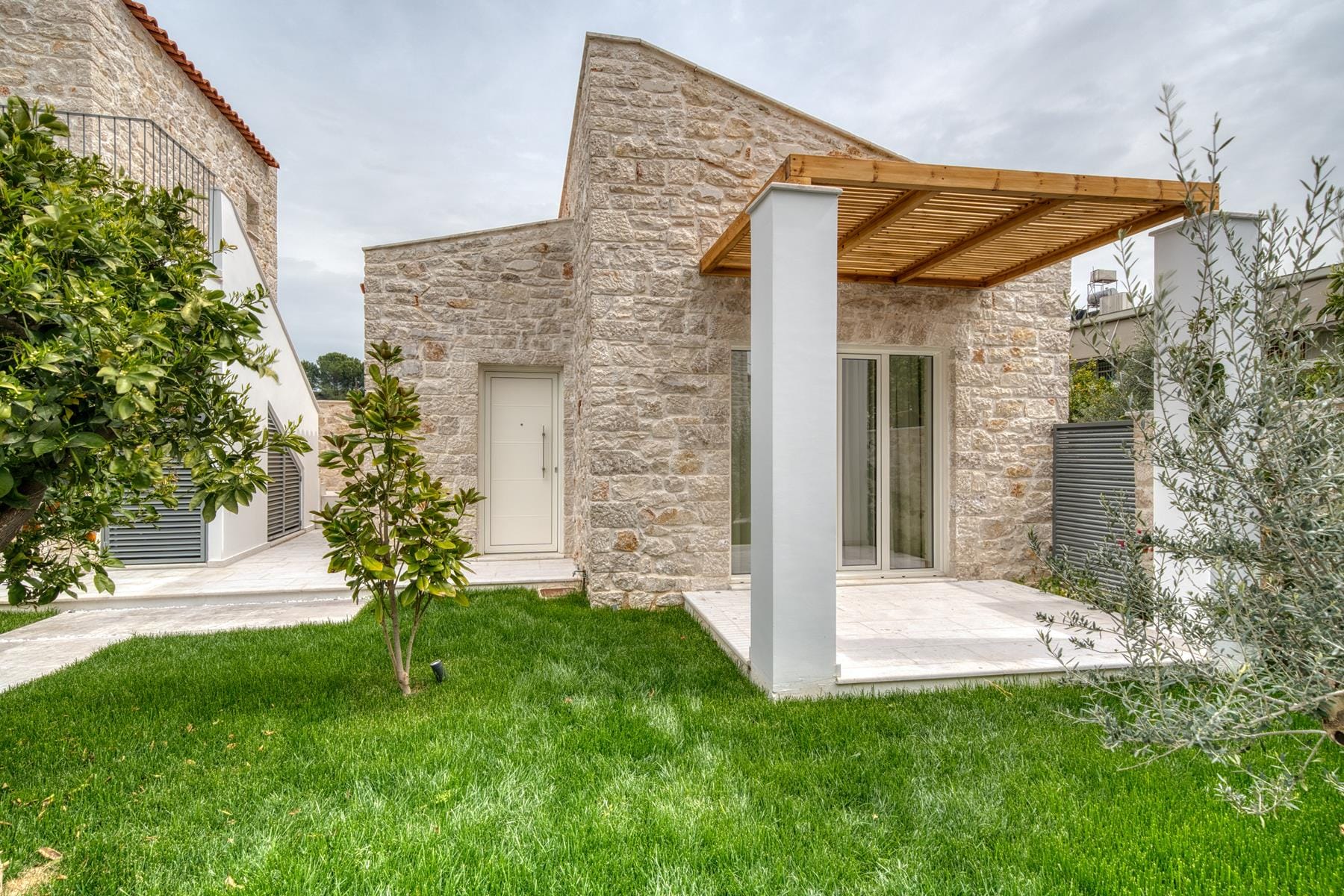 a building with pillars and grass