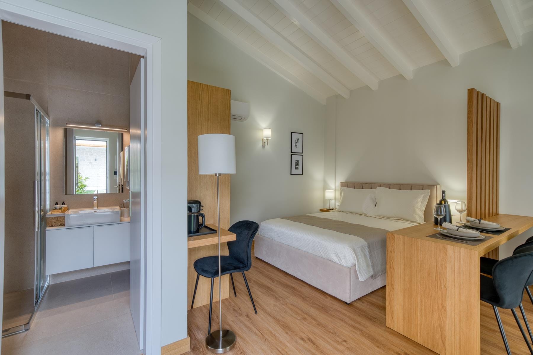 a room with a bed desk and a lamp