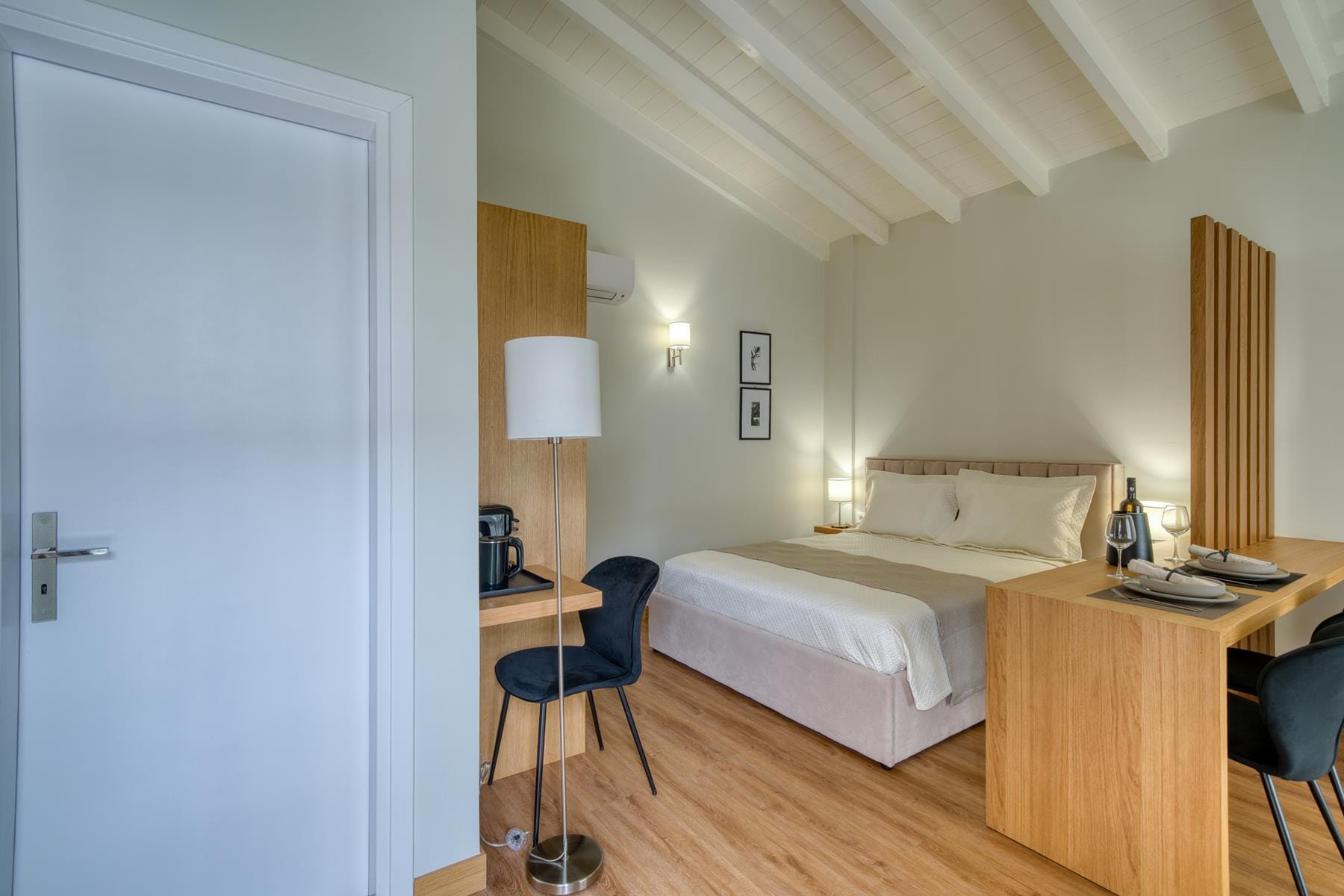 a bedroom with a bed desk and a lamp