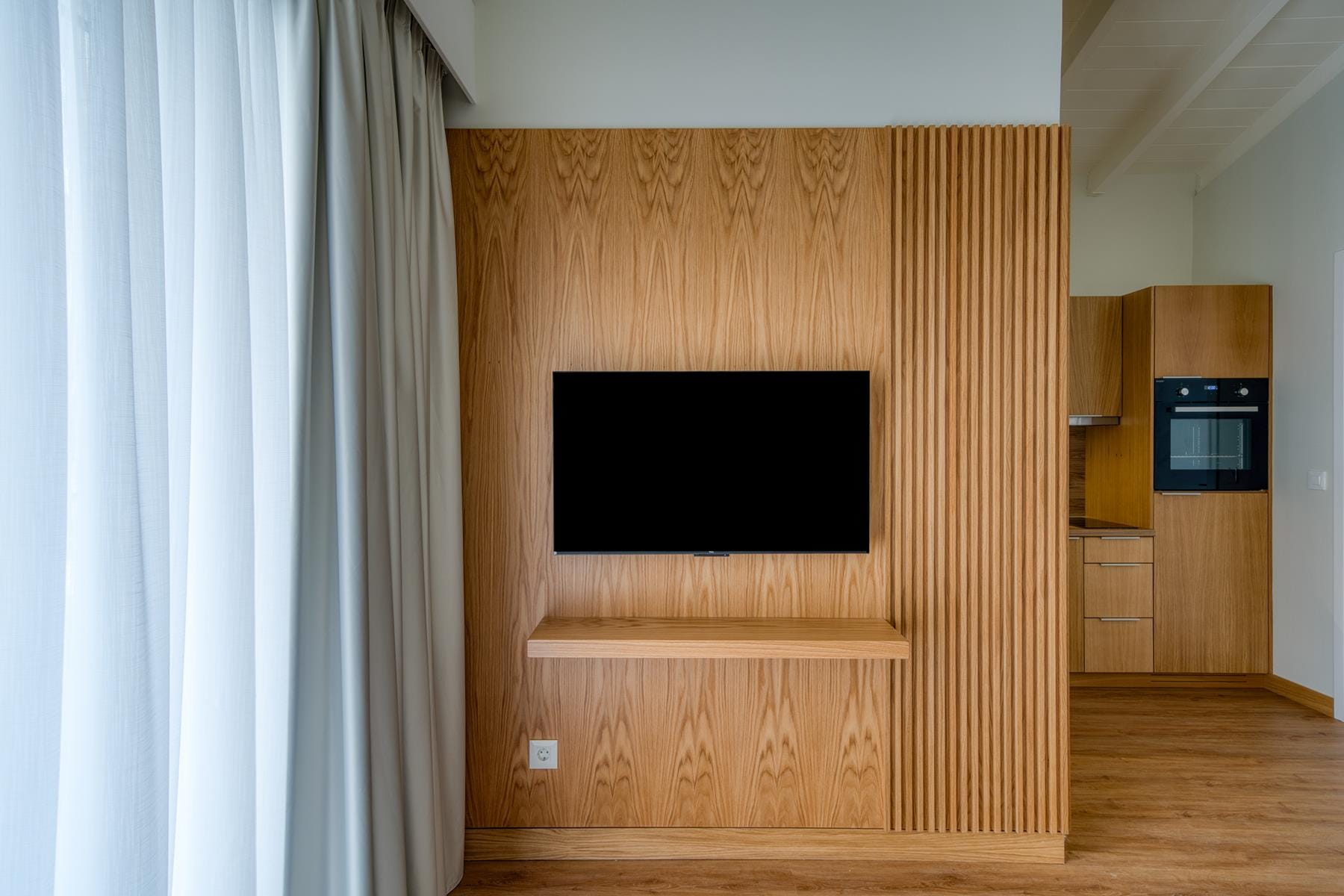 a room with a tv and a shelf