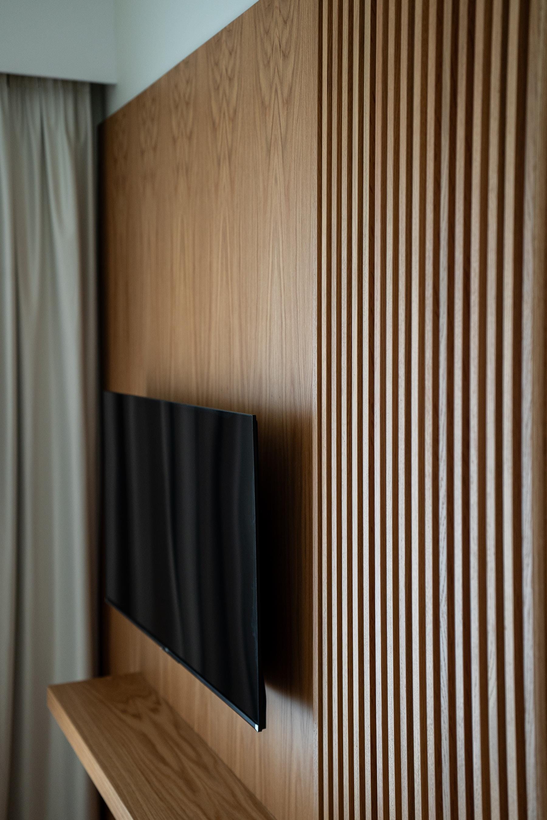 a wood wall with a table and curtains
