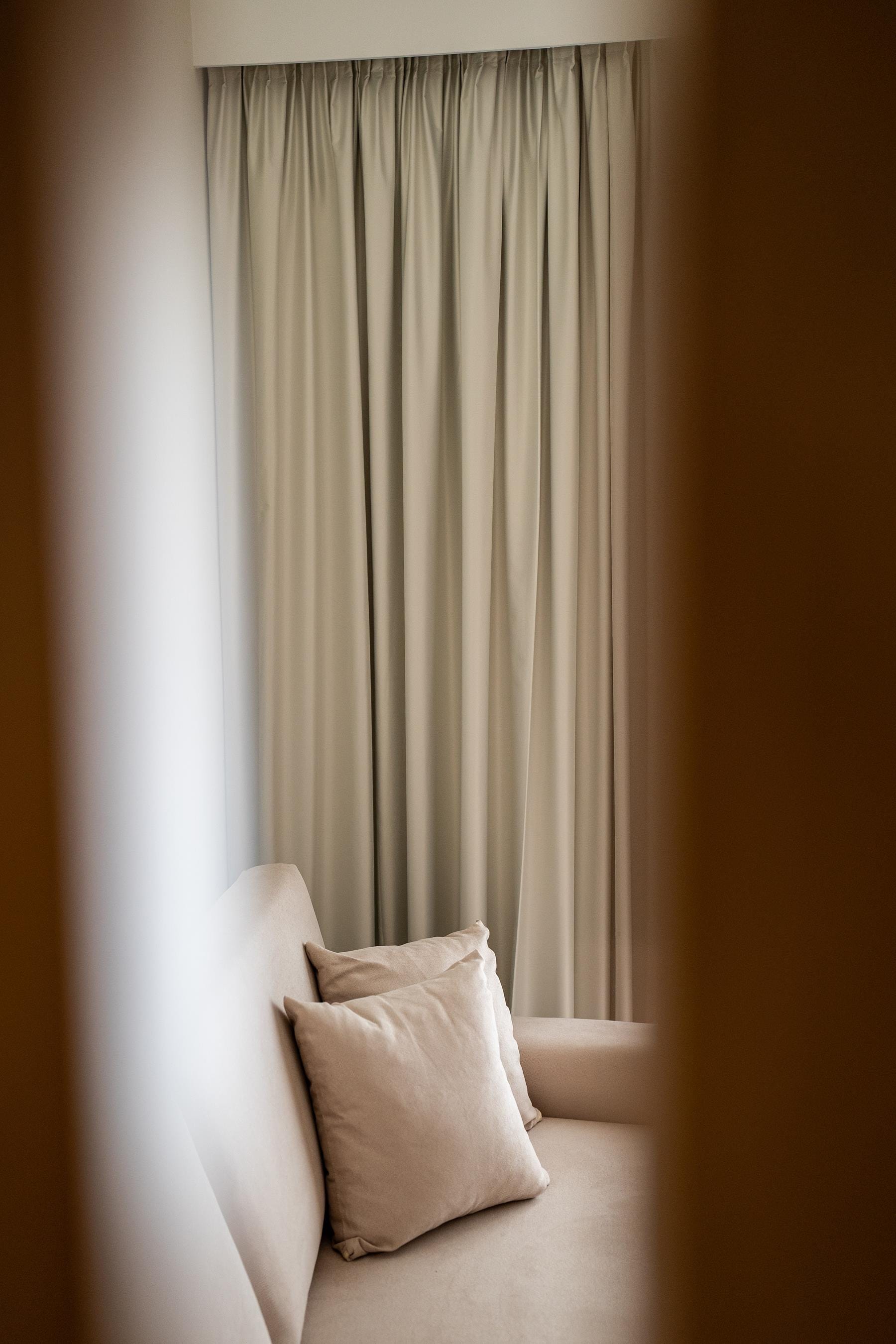 a bed with a white pillow