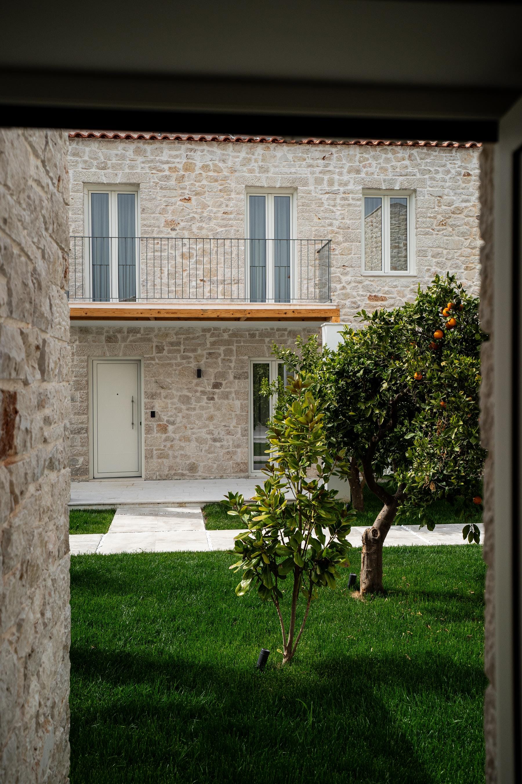 a tree in front of a brick building