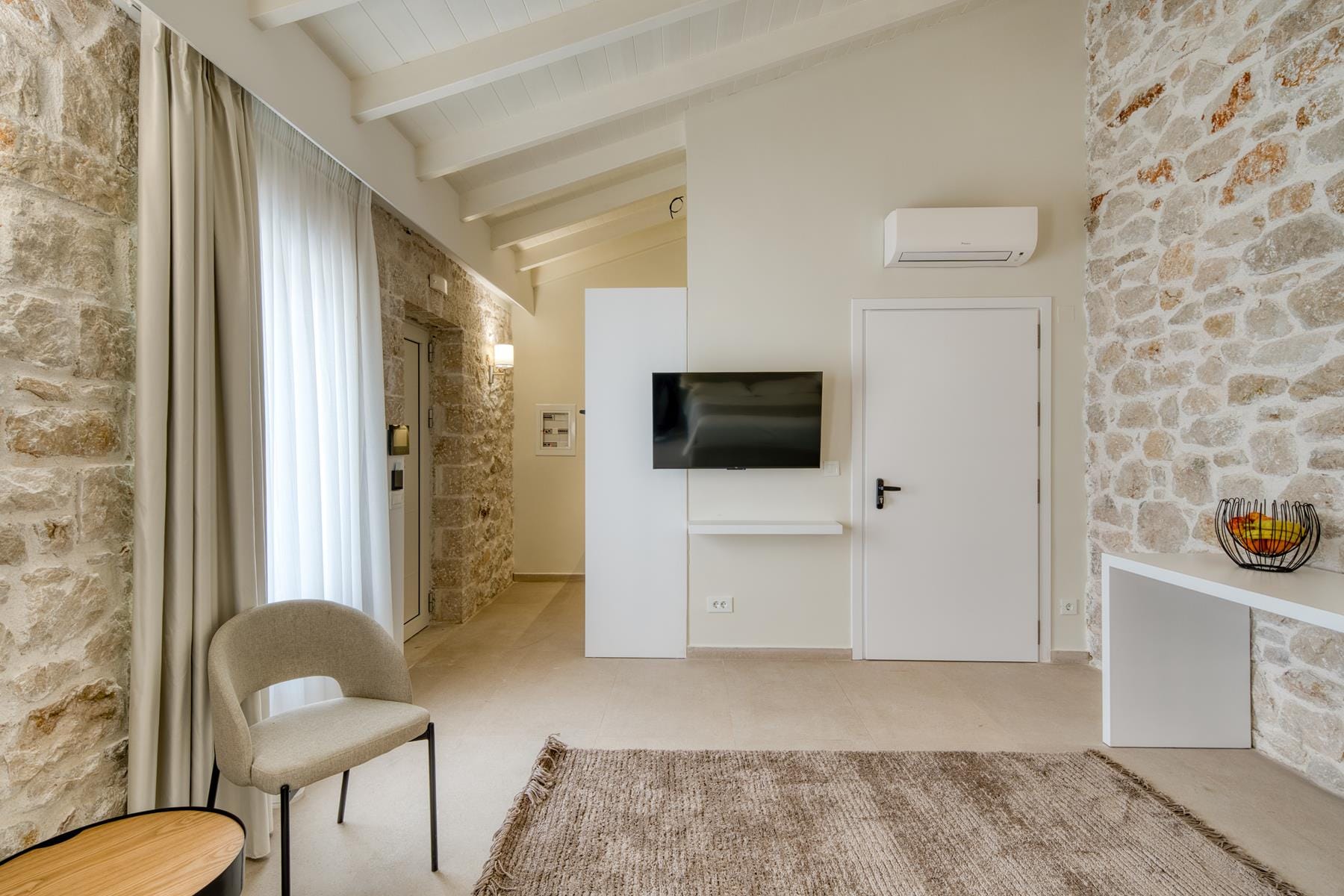 a living room with a tv and a chair