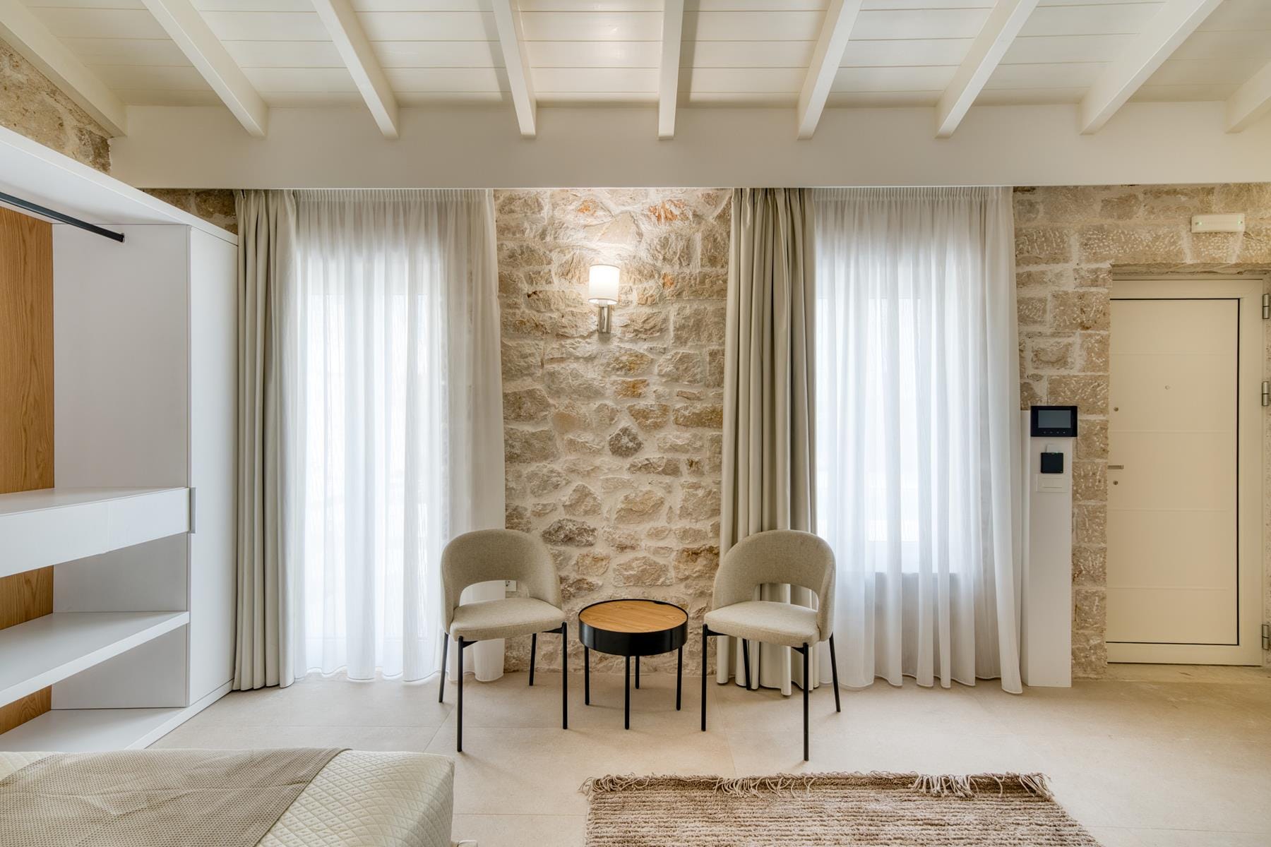 a room with a table chairs and a rug