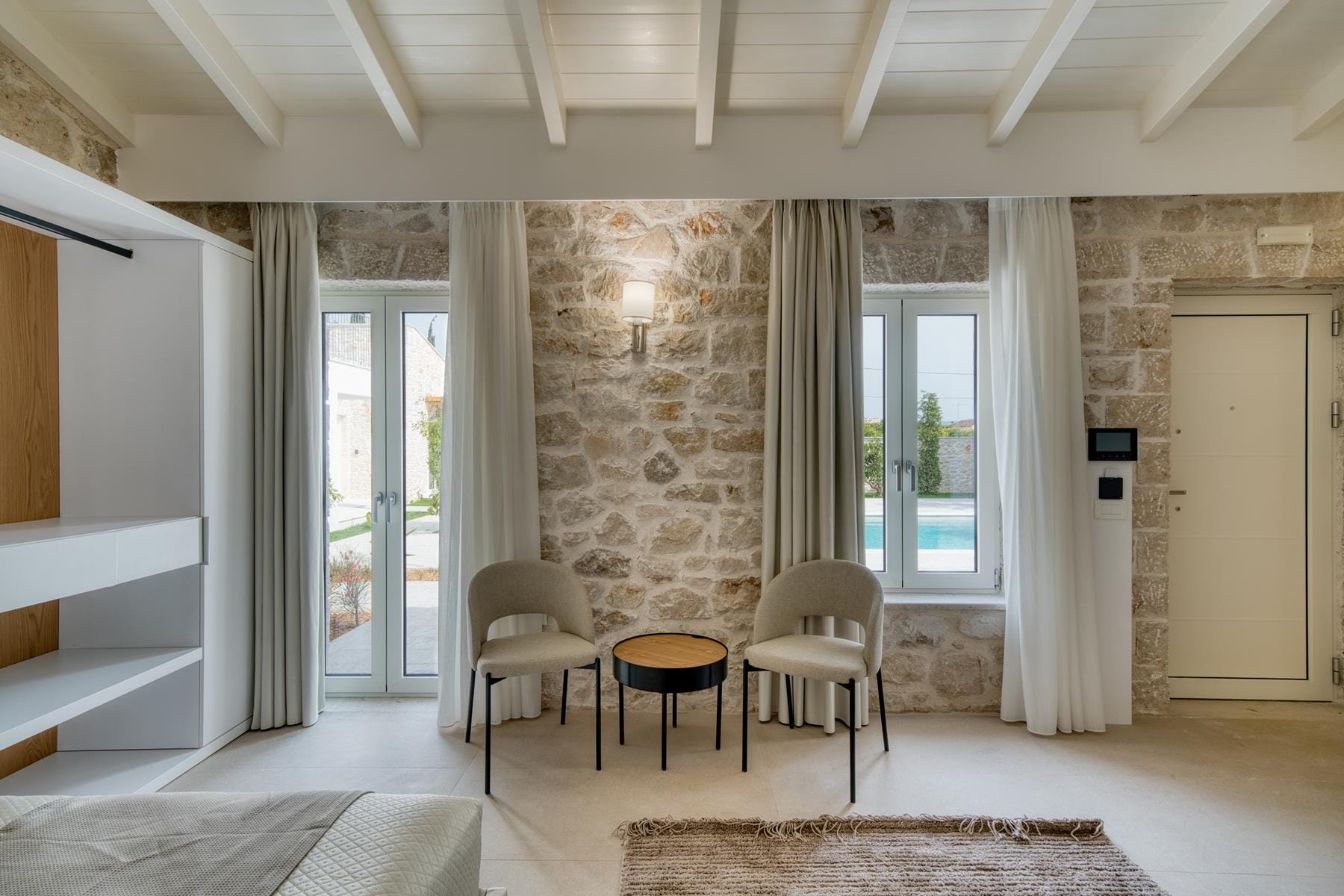 a room with a table chairs and a rug