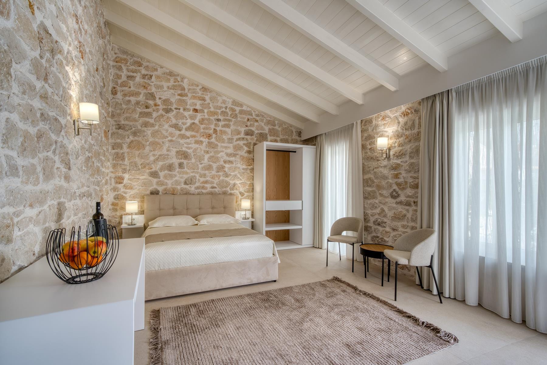 a bedroom with a bed and a couch