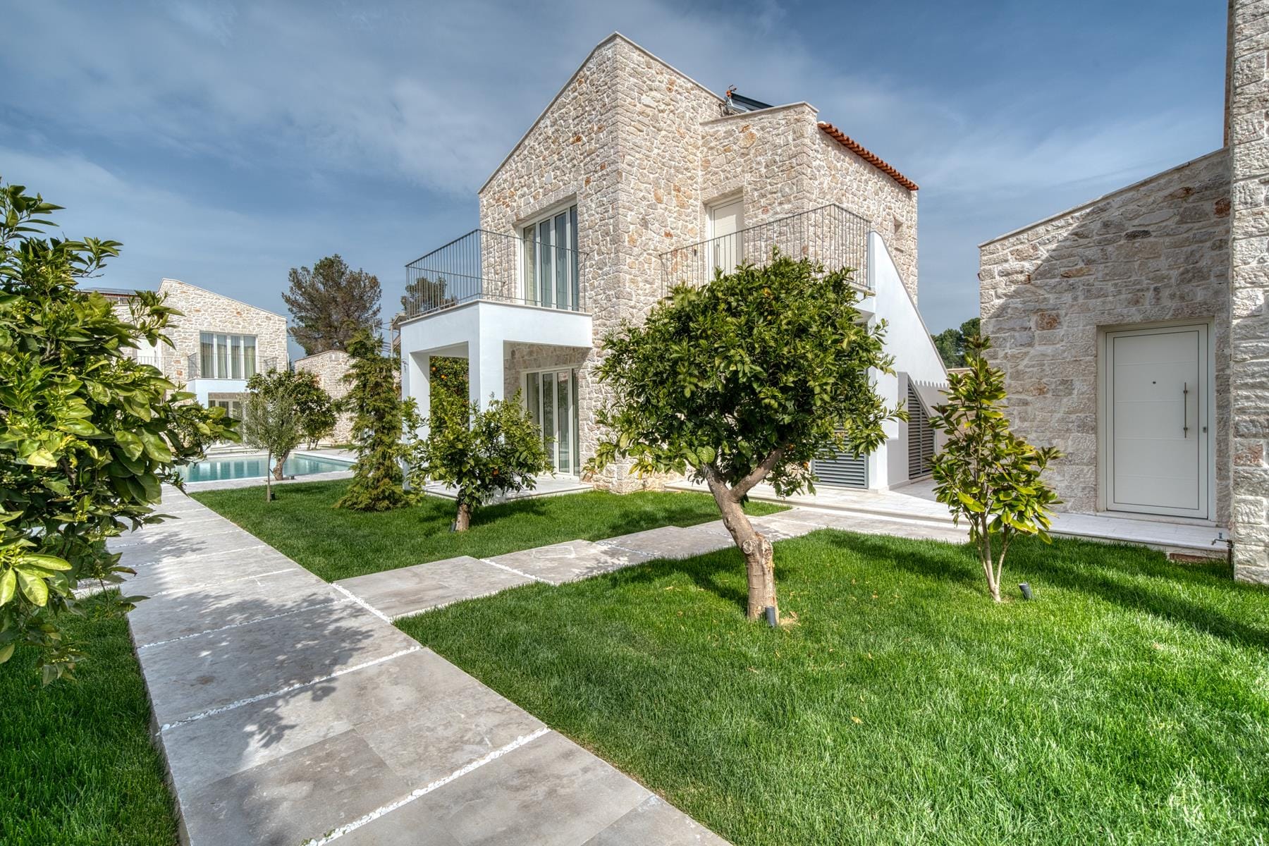 a house with a driveway and trees