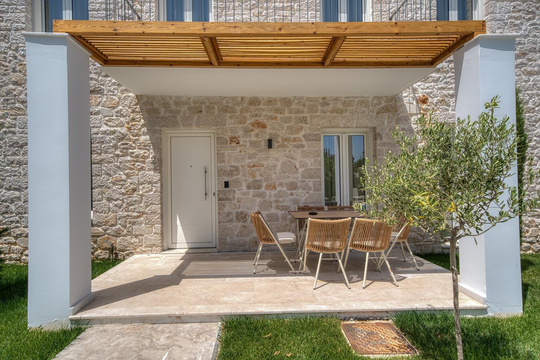 a patio with chairs and a table