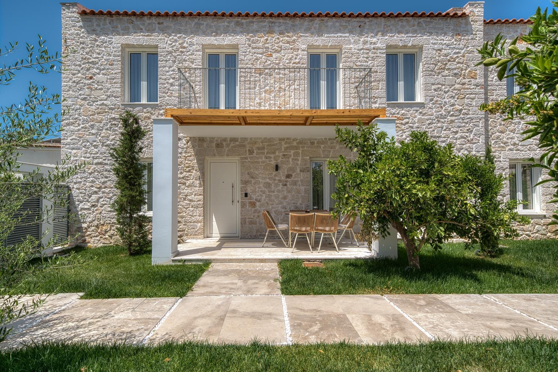 a house with a patio and a table and chairs in the front
