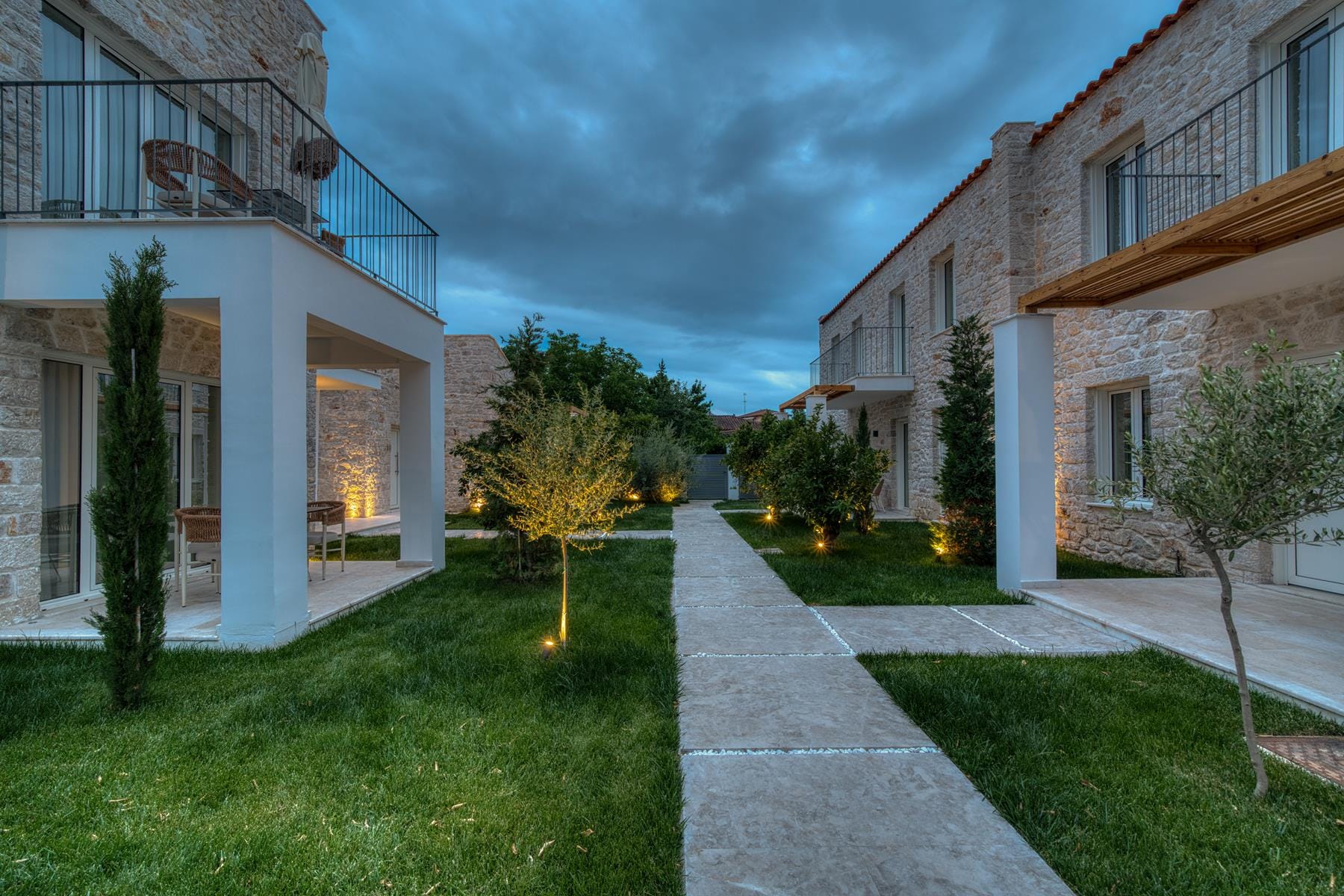 a building with a walkway and grass