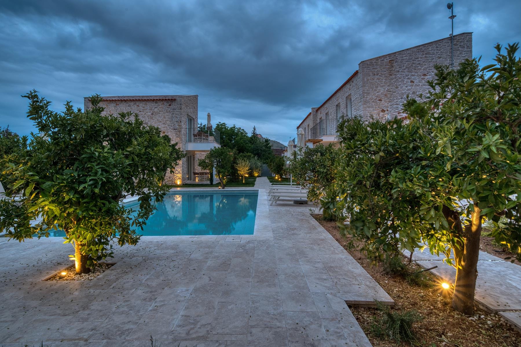 a road with trees and buildings on the side