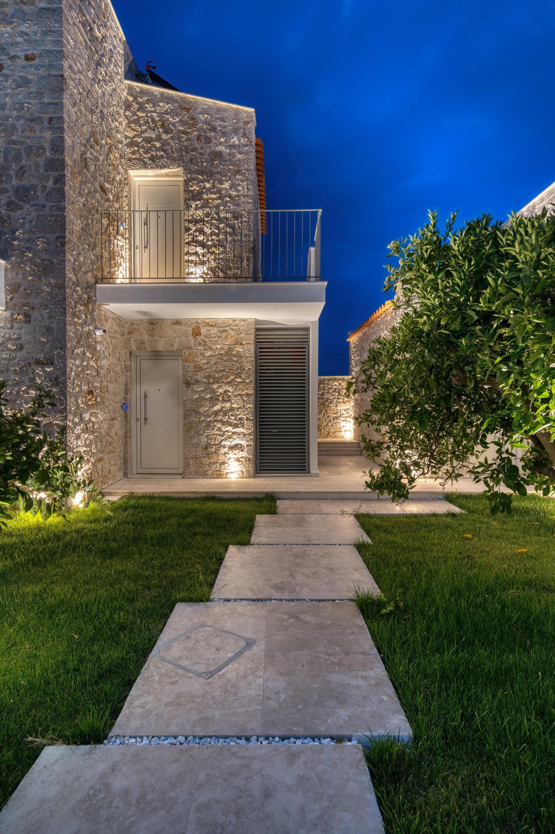 a stone building with a blue gate