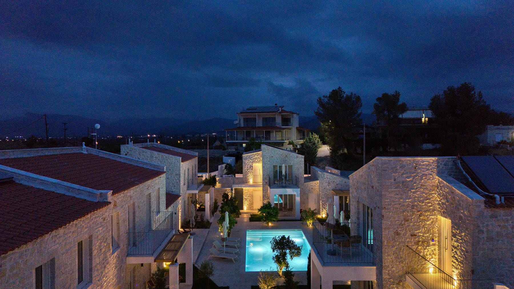 a group of buildings with a pool in the middle