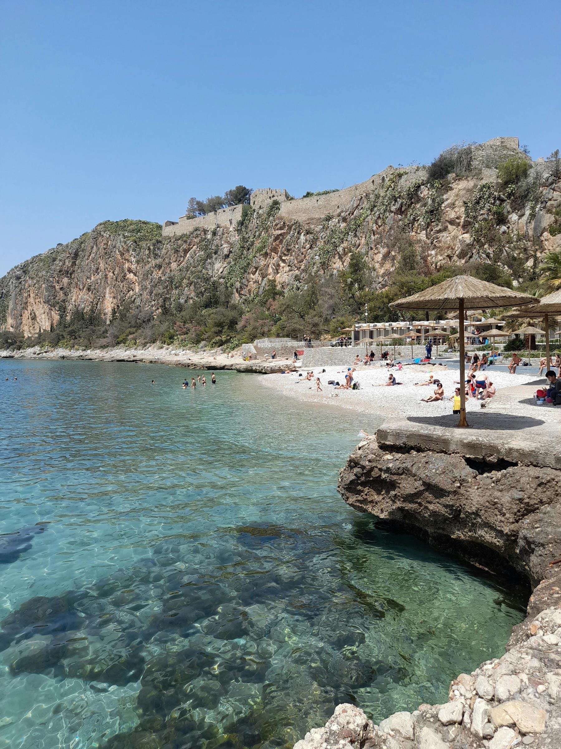 a beach with a rocky cliff
